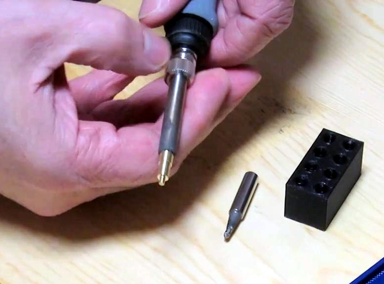 Screwing the soldering iron cover back on