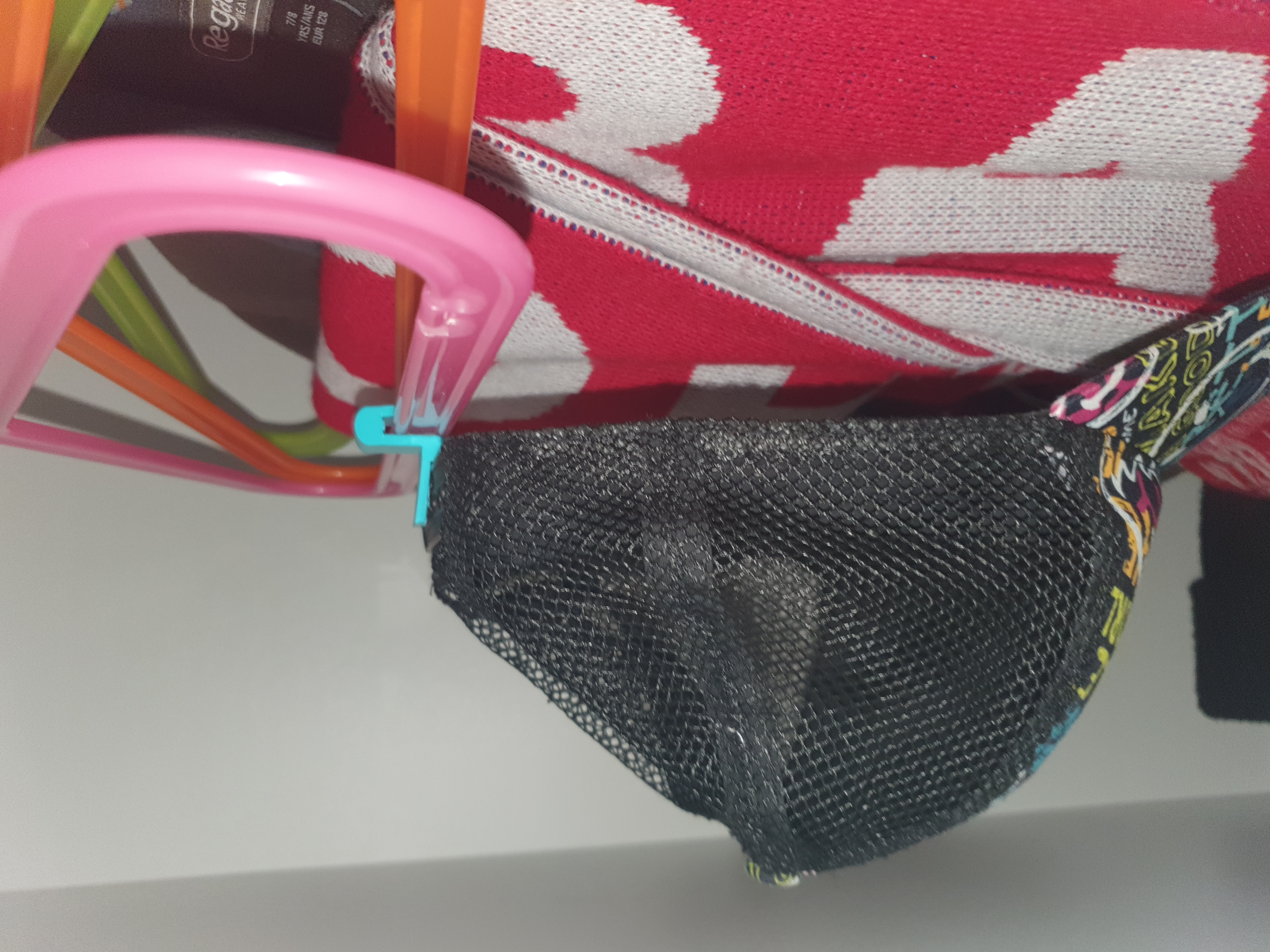 Baseball cap holder that attaches to a clothes hanger