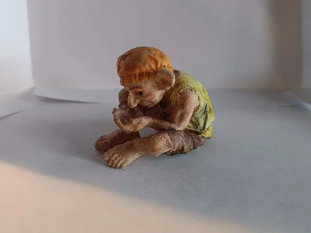 Goblin hiding something in his hands
