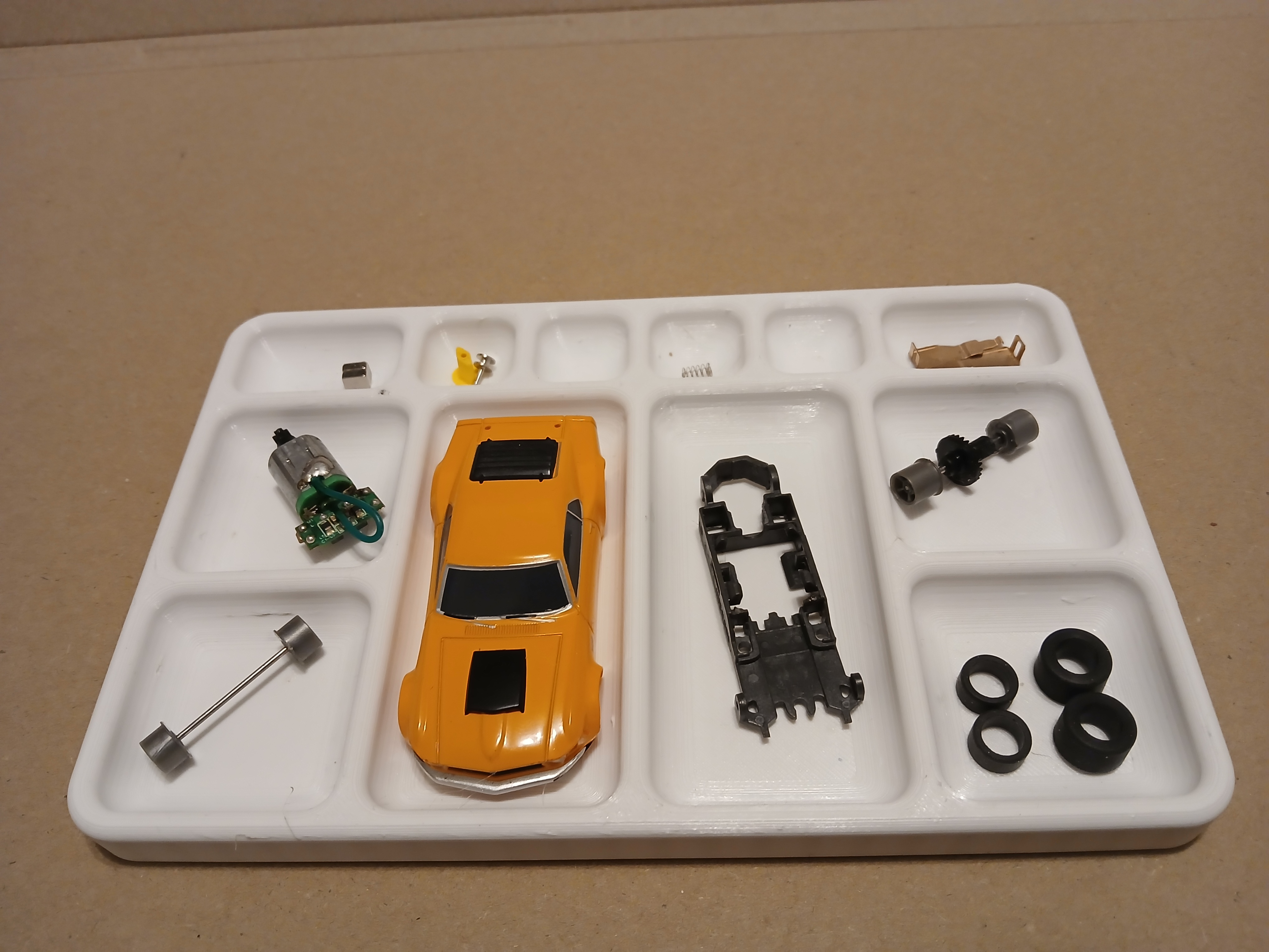 Parts tray designed around 1/64th slot car.