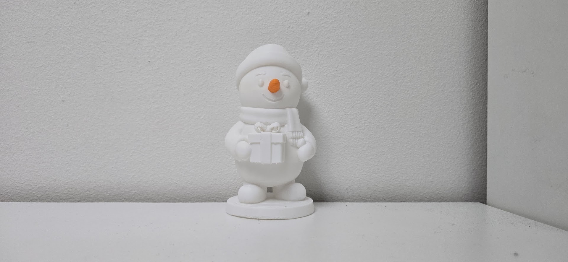 Smiling Snowman with Gift Christmas Figurine