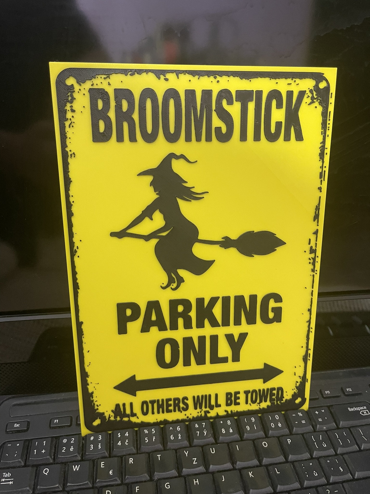 Broomstick parking sign