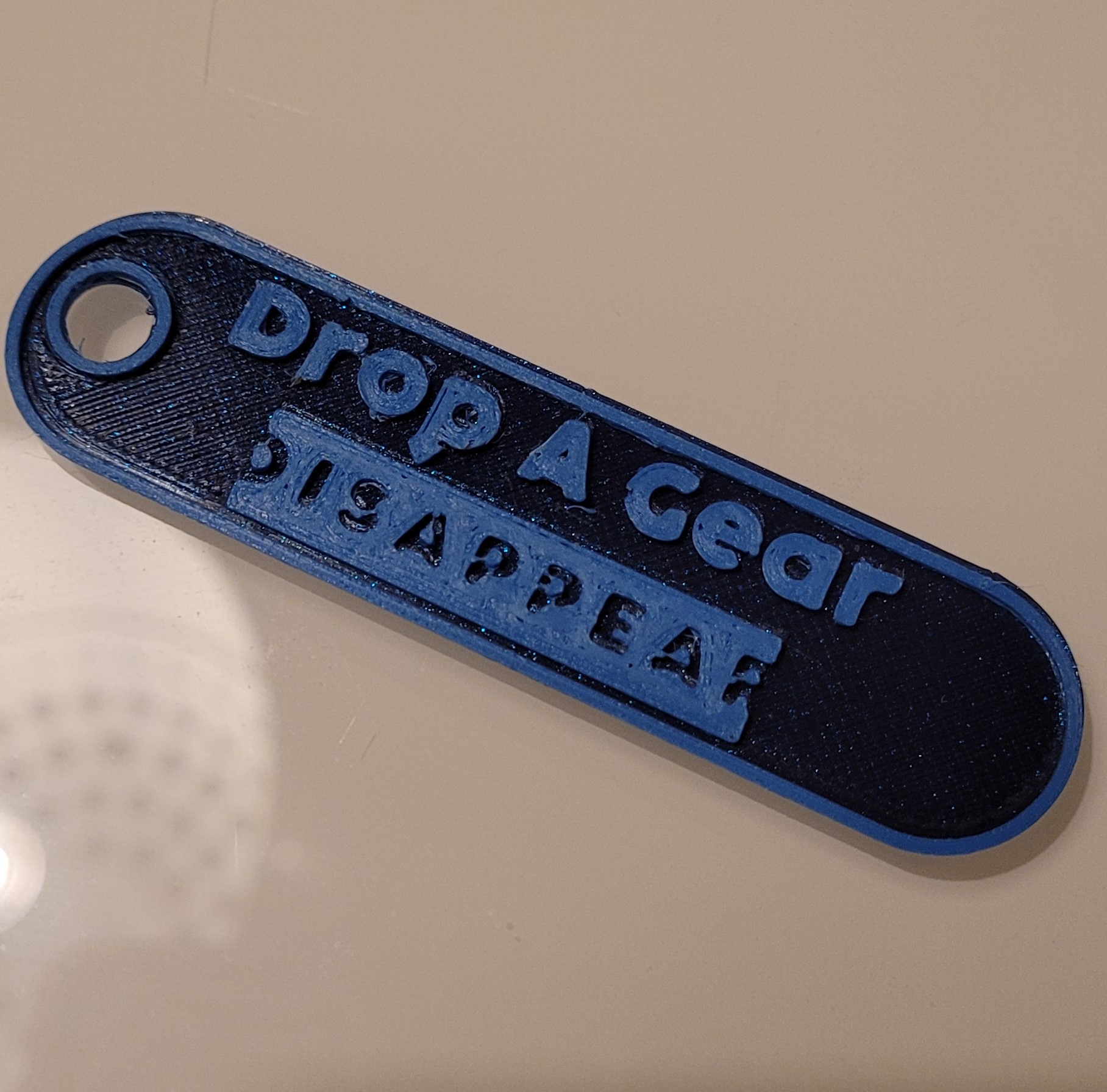 Drop A Gear Disappear key tag