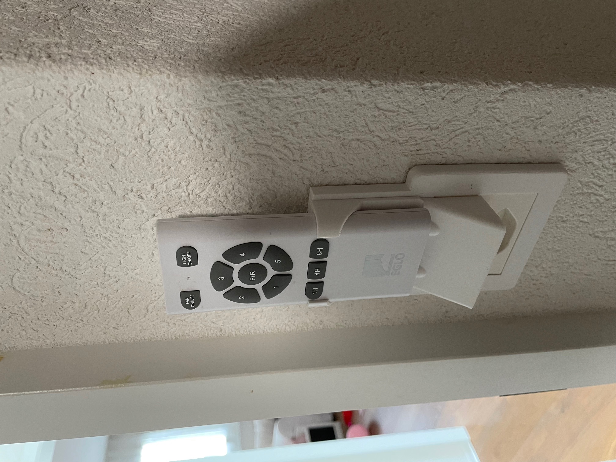 Light switch cover with remote control holder