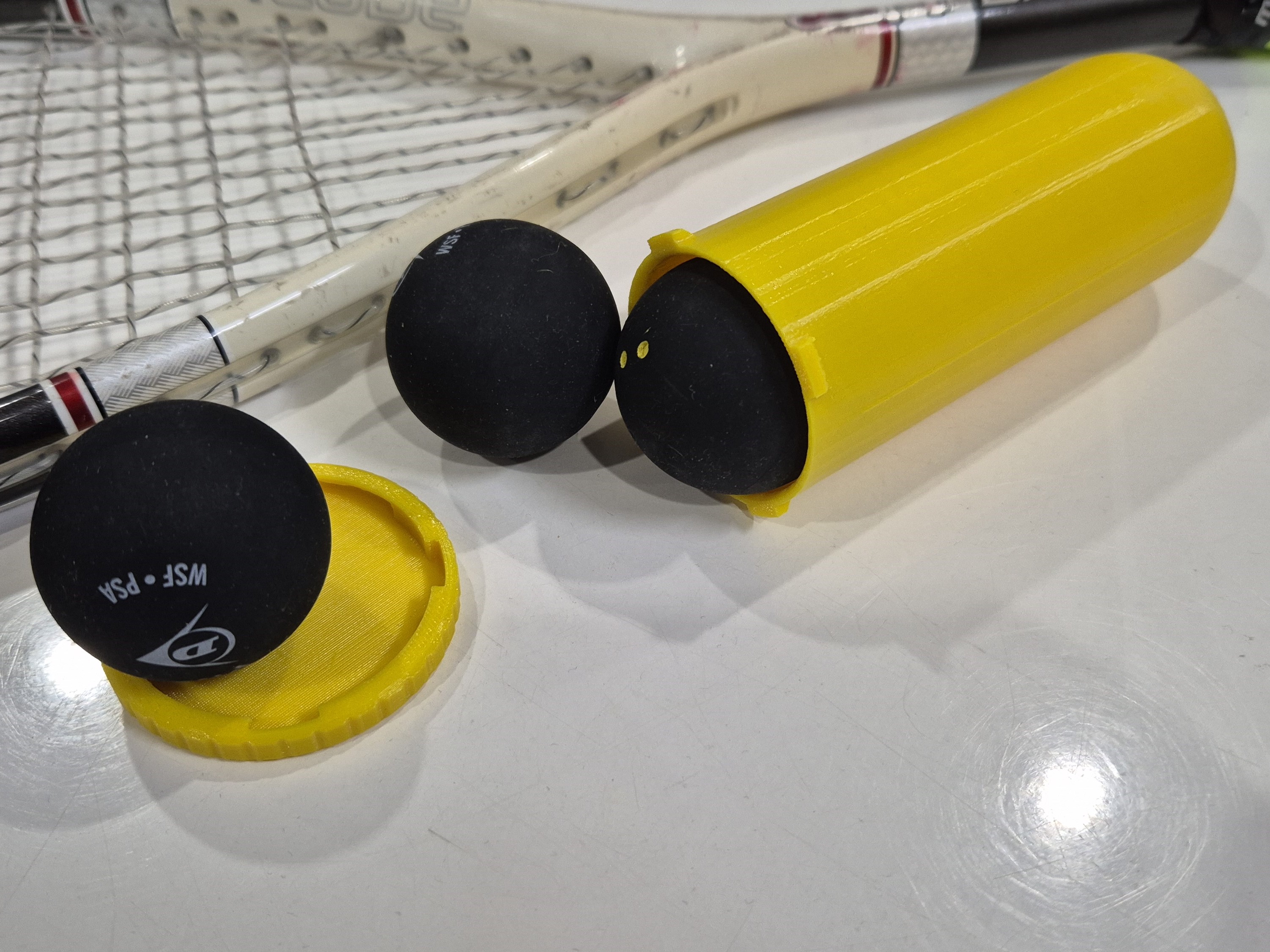 Storage container for squash balls