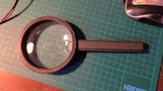 Frame for magnifying lens