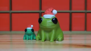 Fred the Frog but he's wearing a Santa Hat