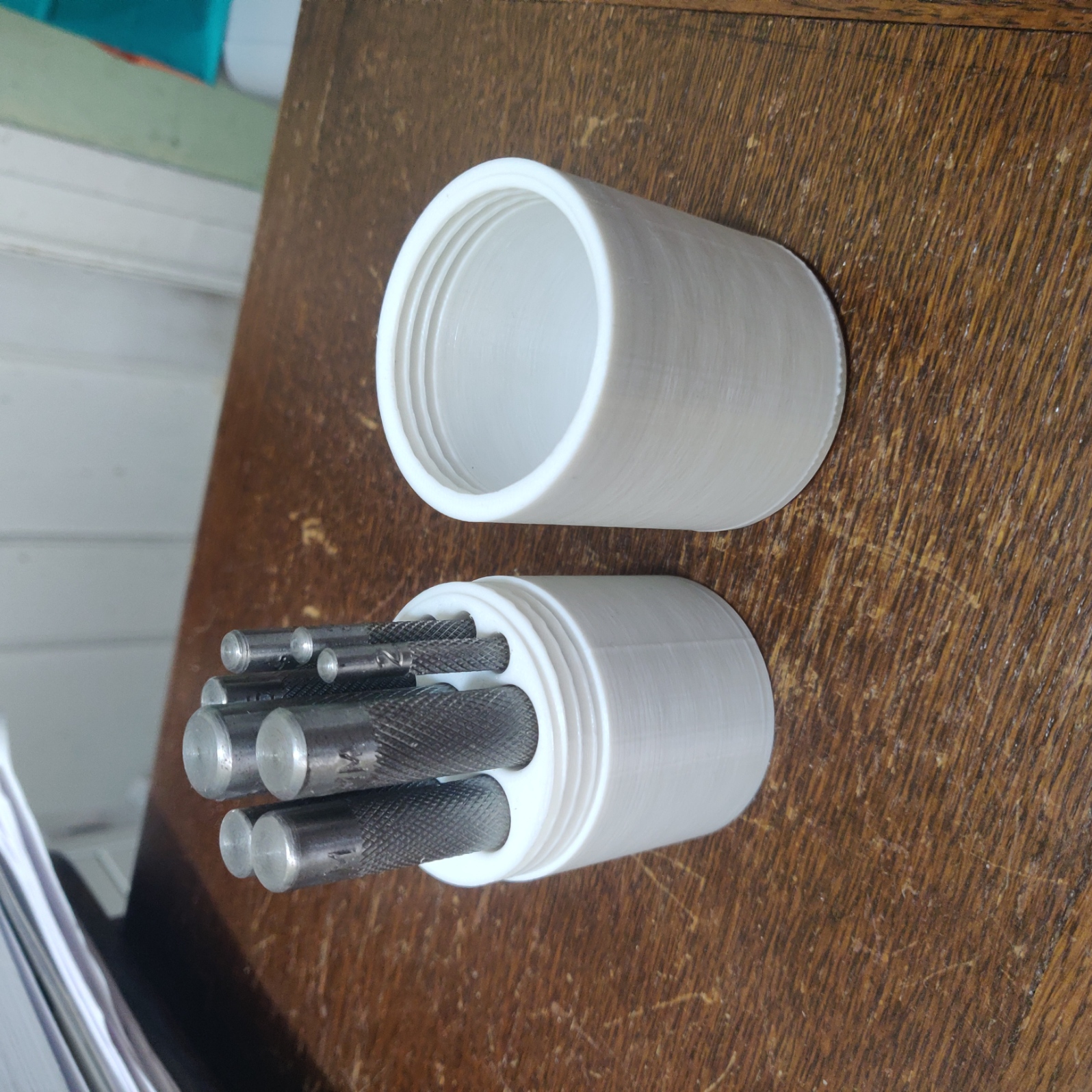 Metric leather punch container