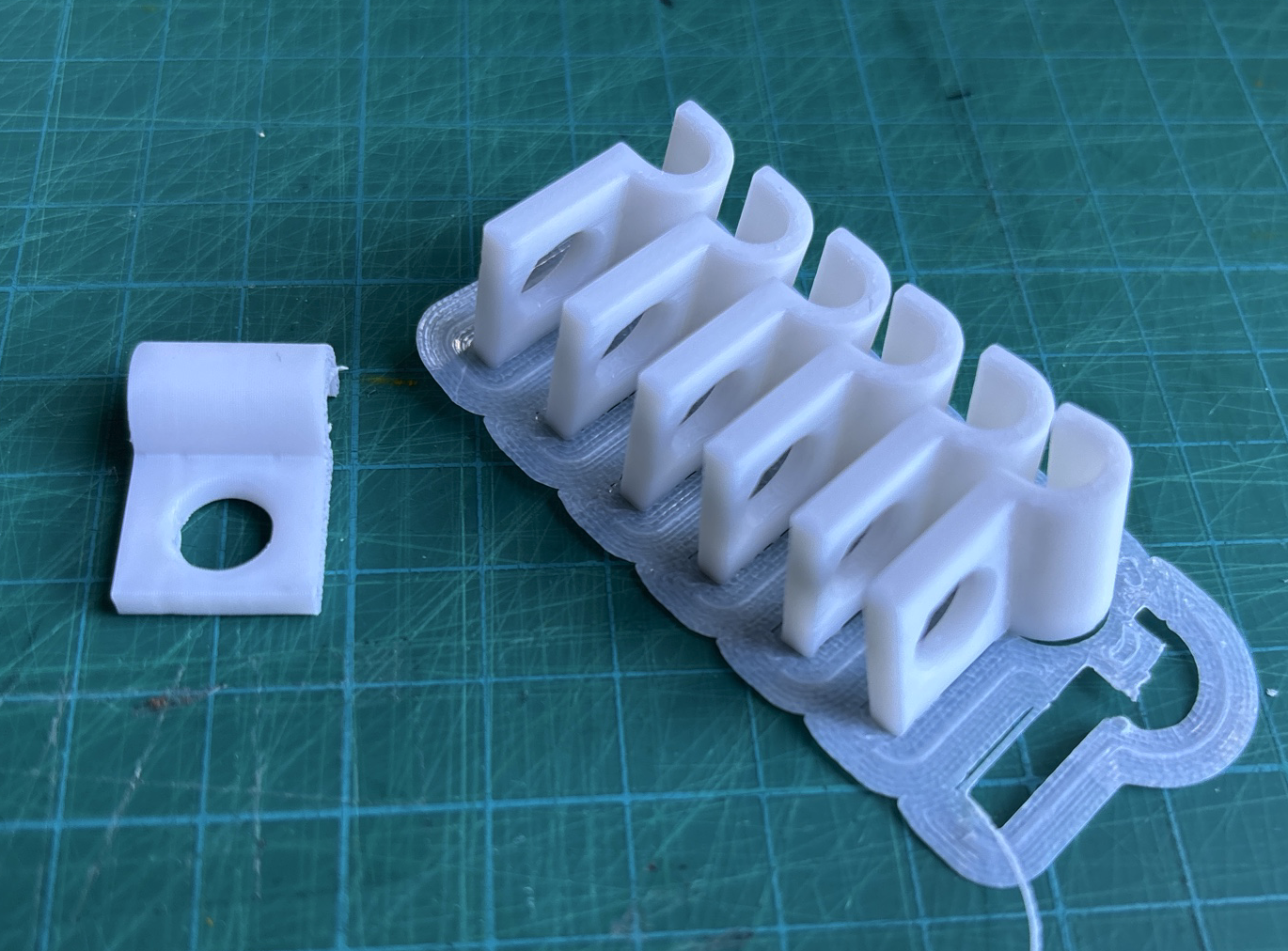 Cable clip/holder for multiboard/underware