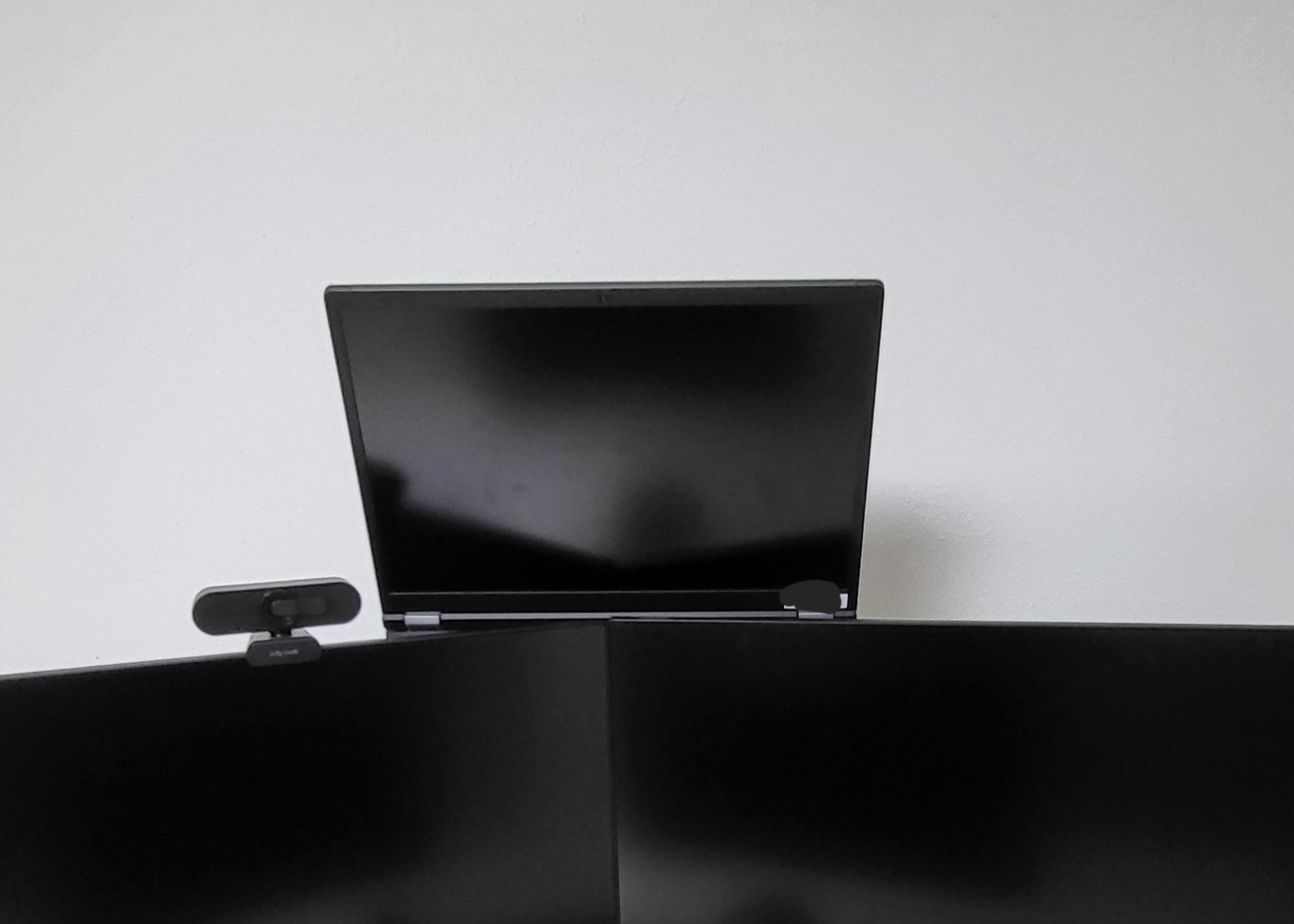 Laptop holder behind monitors
