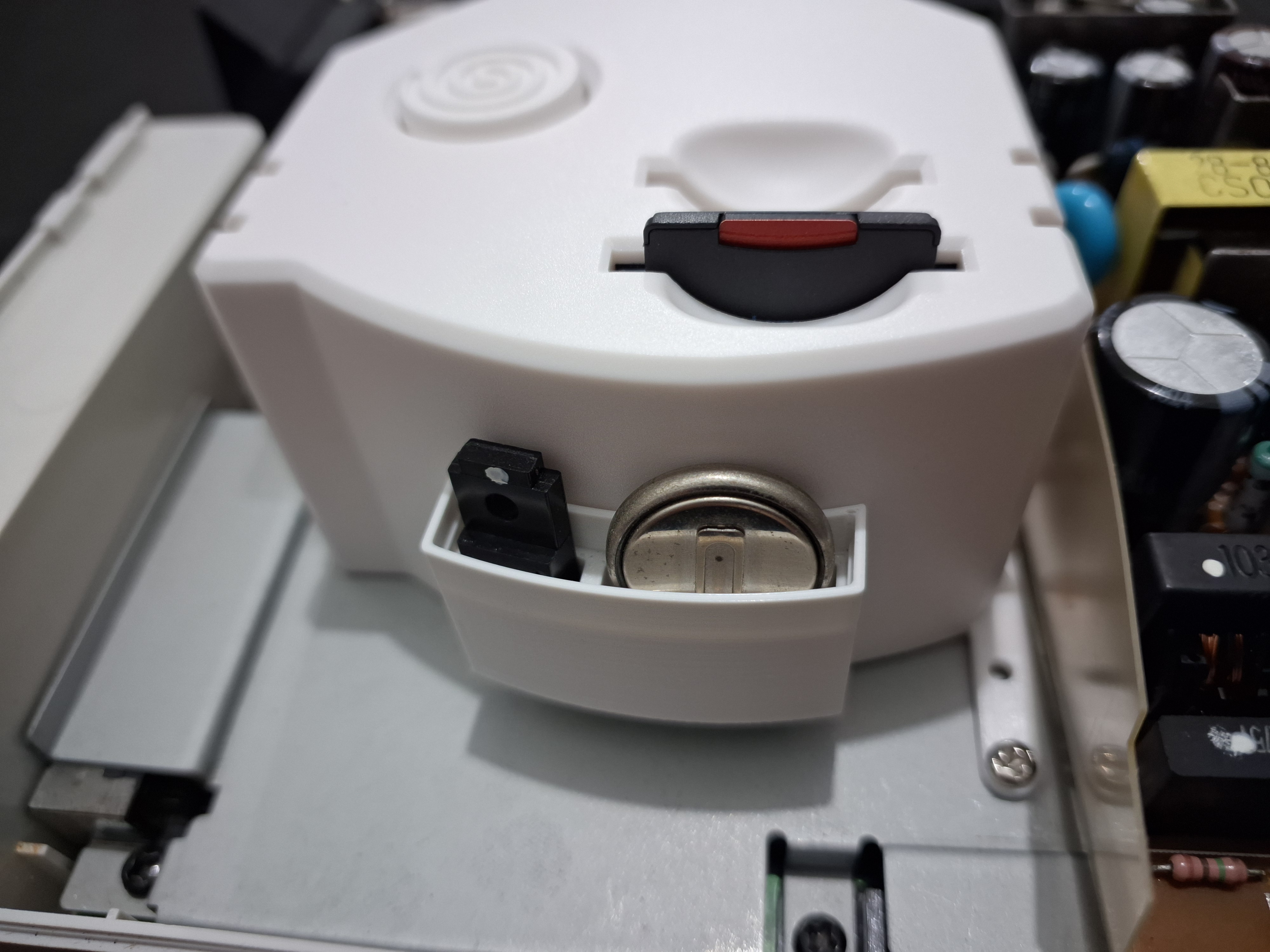 Compartment for regulator and battery for the Dreamcast