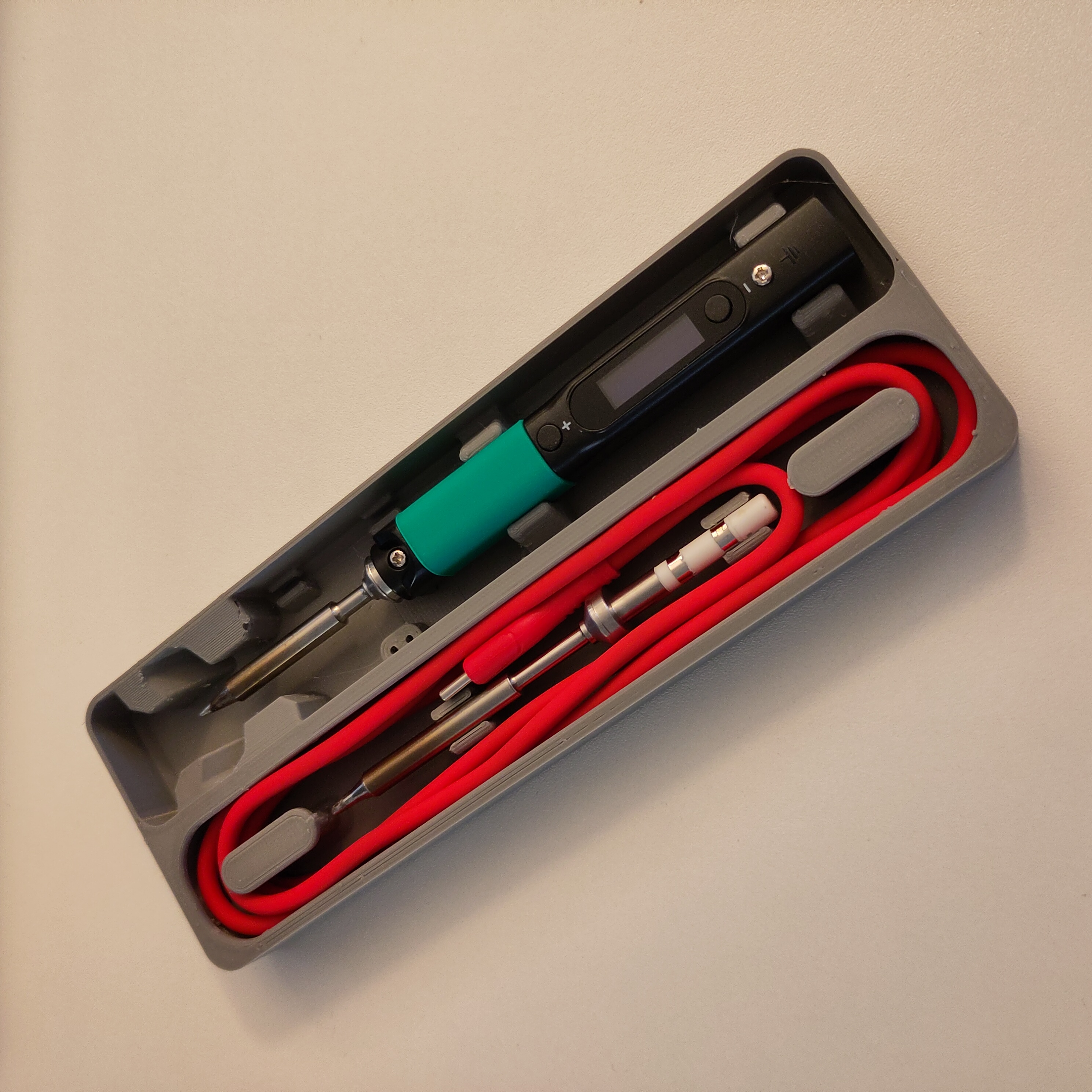 Pinecil insert with tip holder in cable compartment