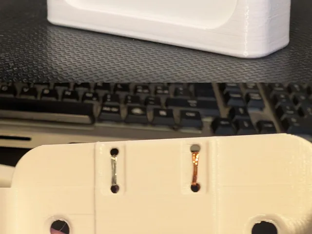 Wall mount for IKEA Badring water sensor, with the option of attaching a cord to extend the sensor.