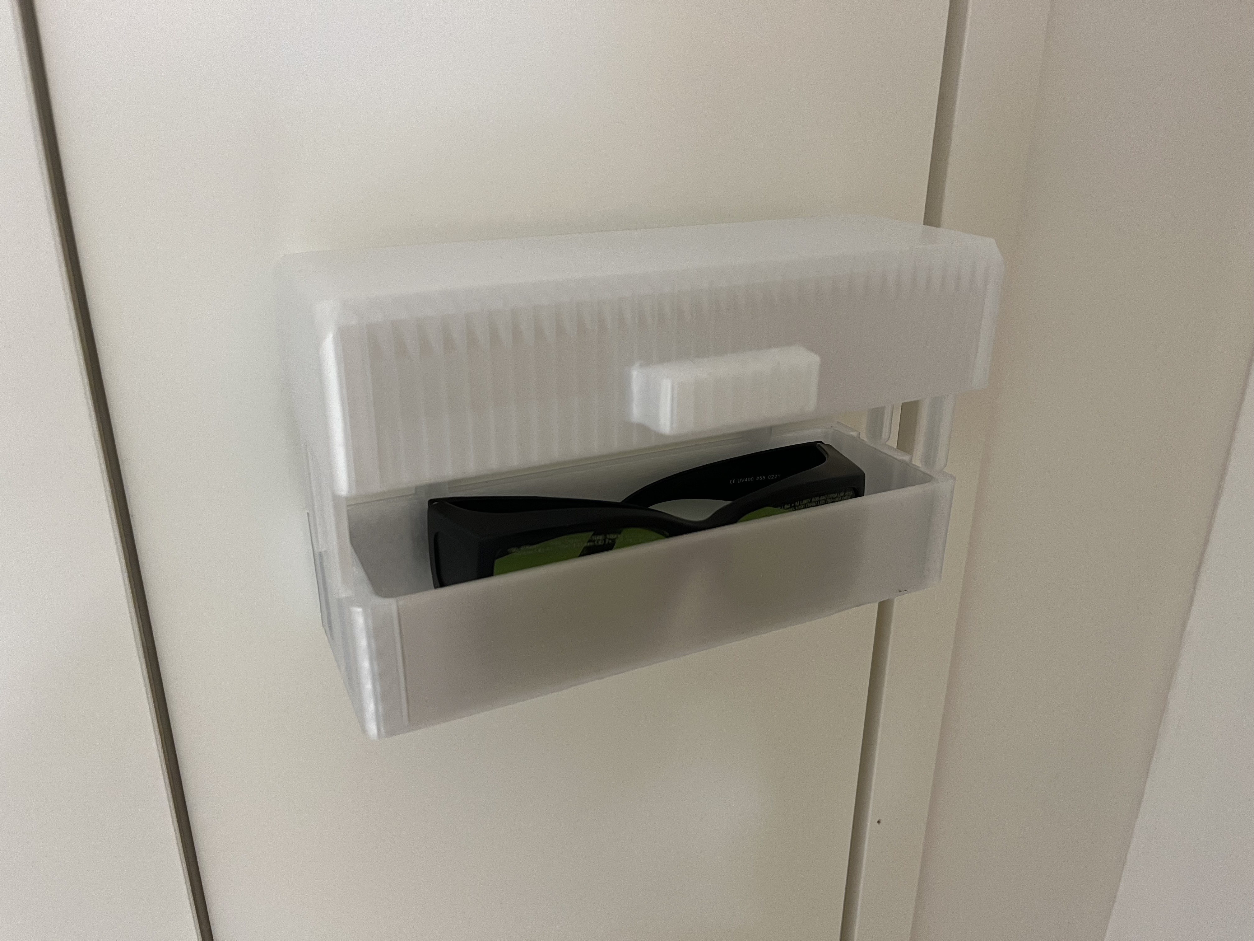 Wall mounted safety goggle pocket