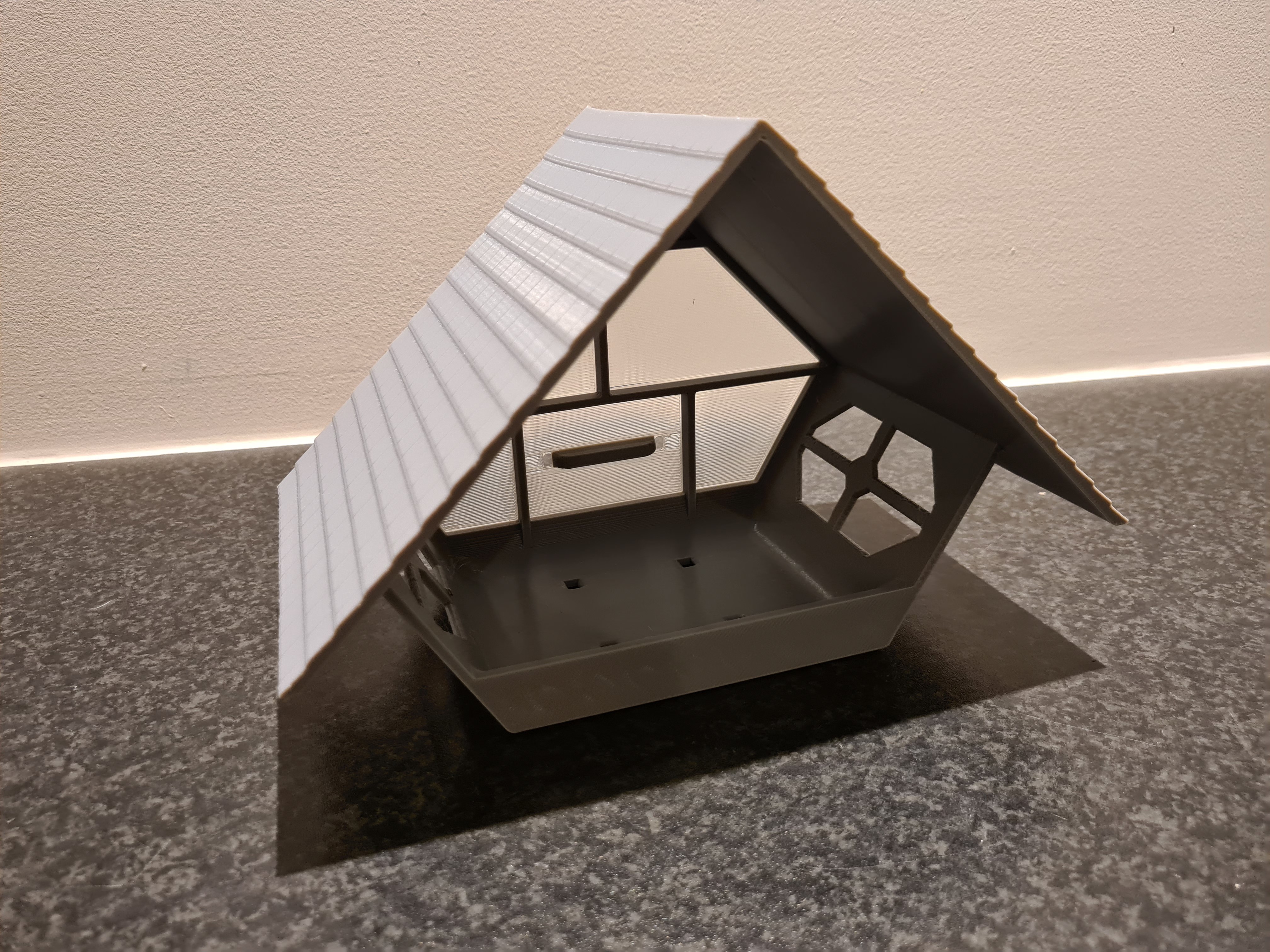 Cozy looking bird feeder with (semi-) transparent back