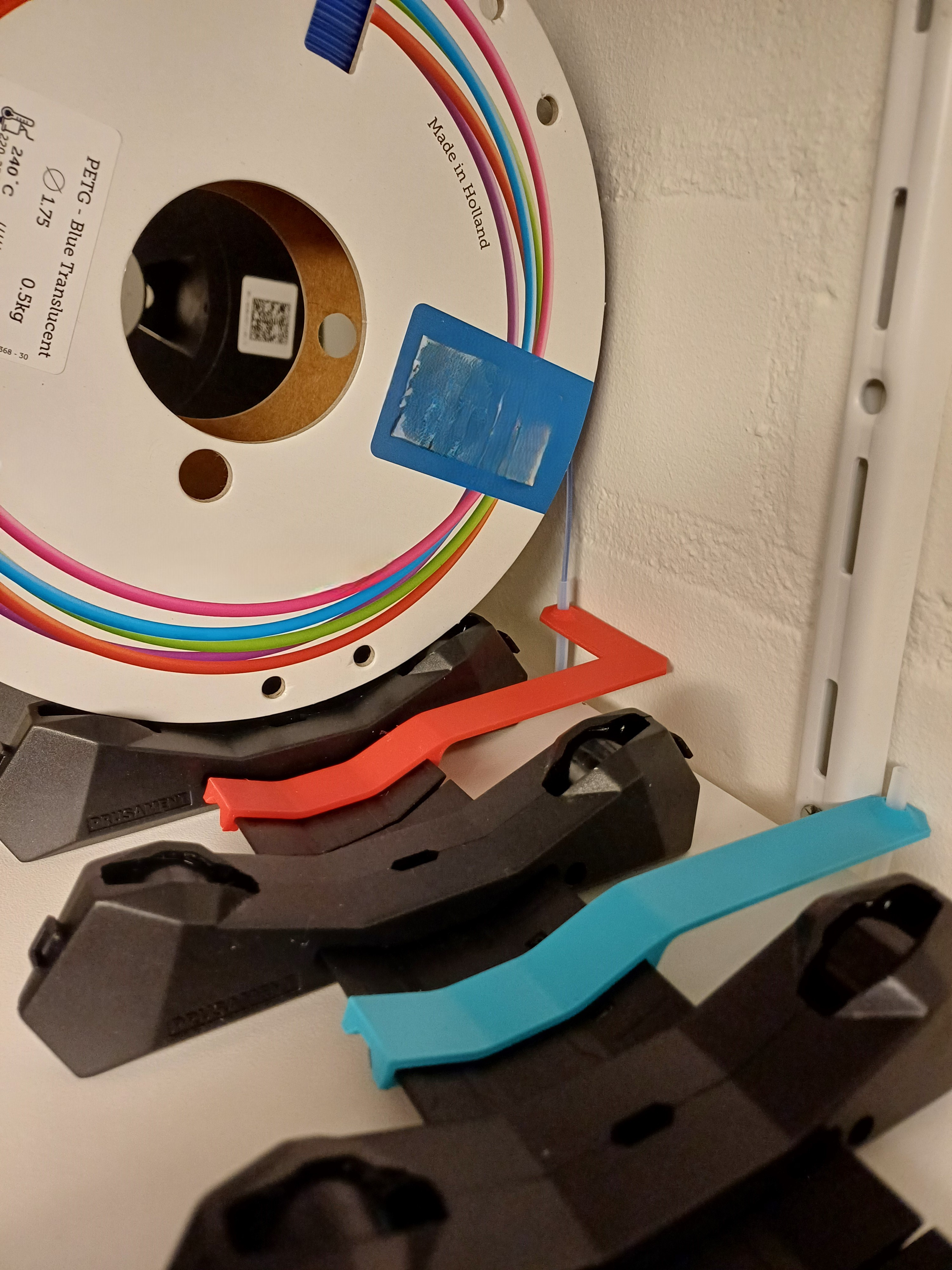 PTFE holder used for the injection molded Spool holder - R4 with the hole relocated and rotated for a spool that is less wide.
