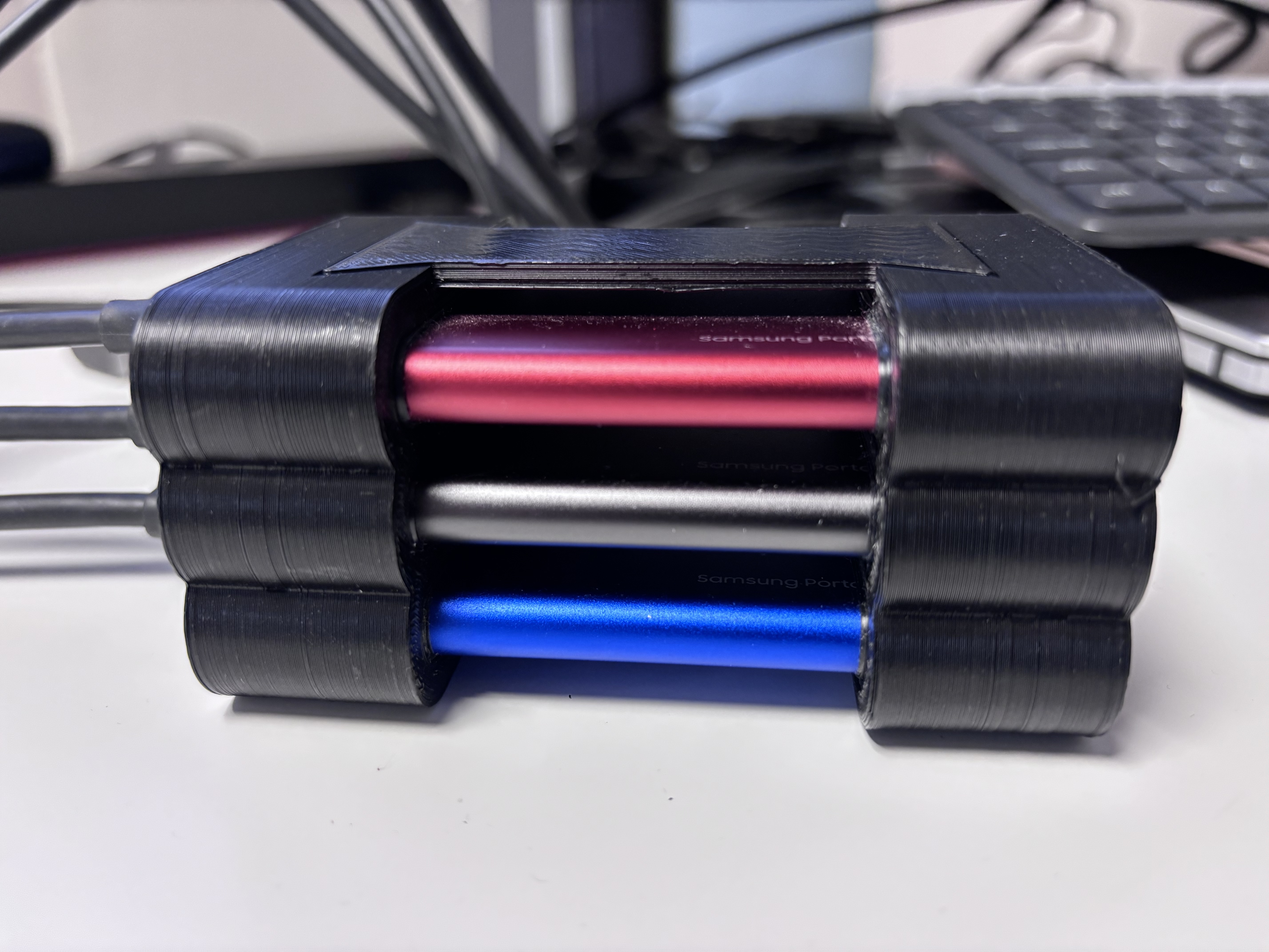 Stackable enclosure for three Samsung Portable T7 drives.