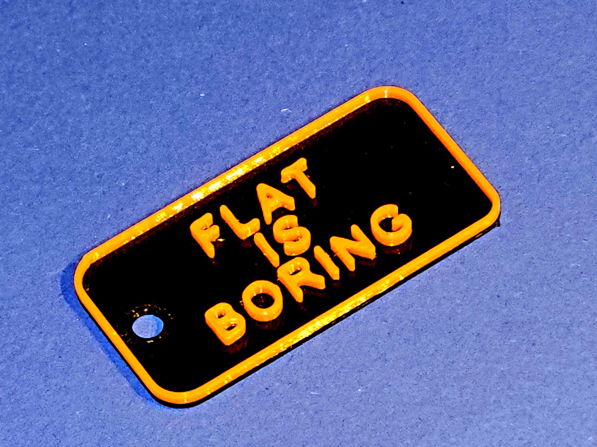 Keytag "Flat is boring", 3D-Slogan