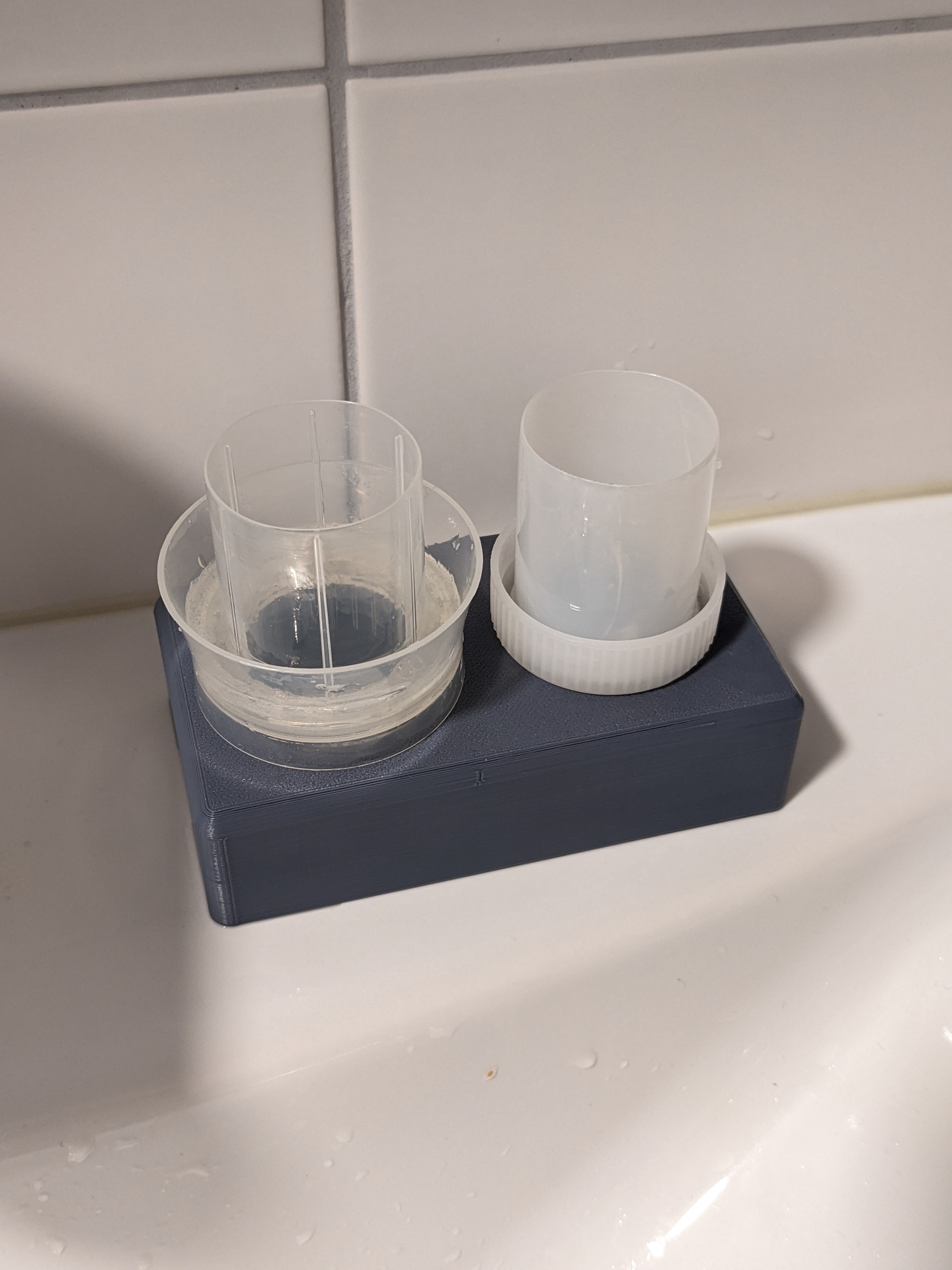 Detergent and fabric softener dosing cap holder