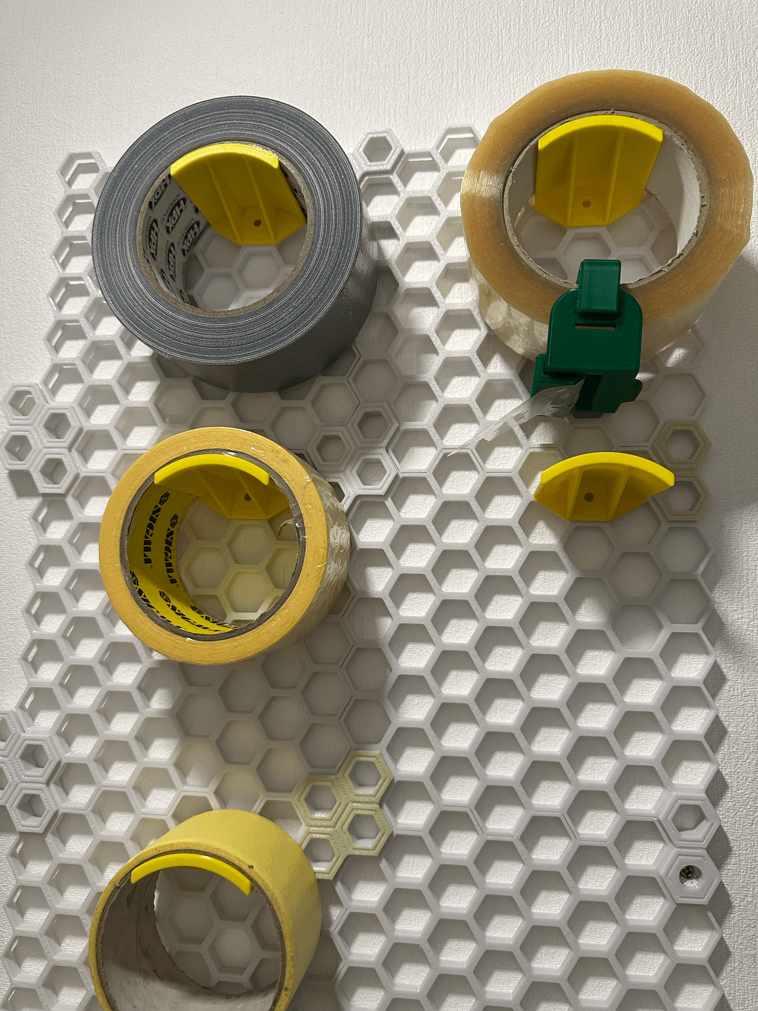 Honeycomb hook for tape (scotch). No screws needed.