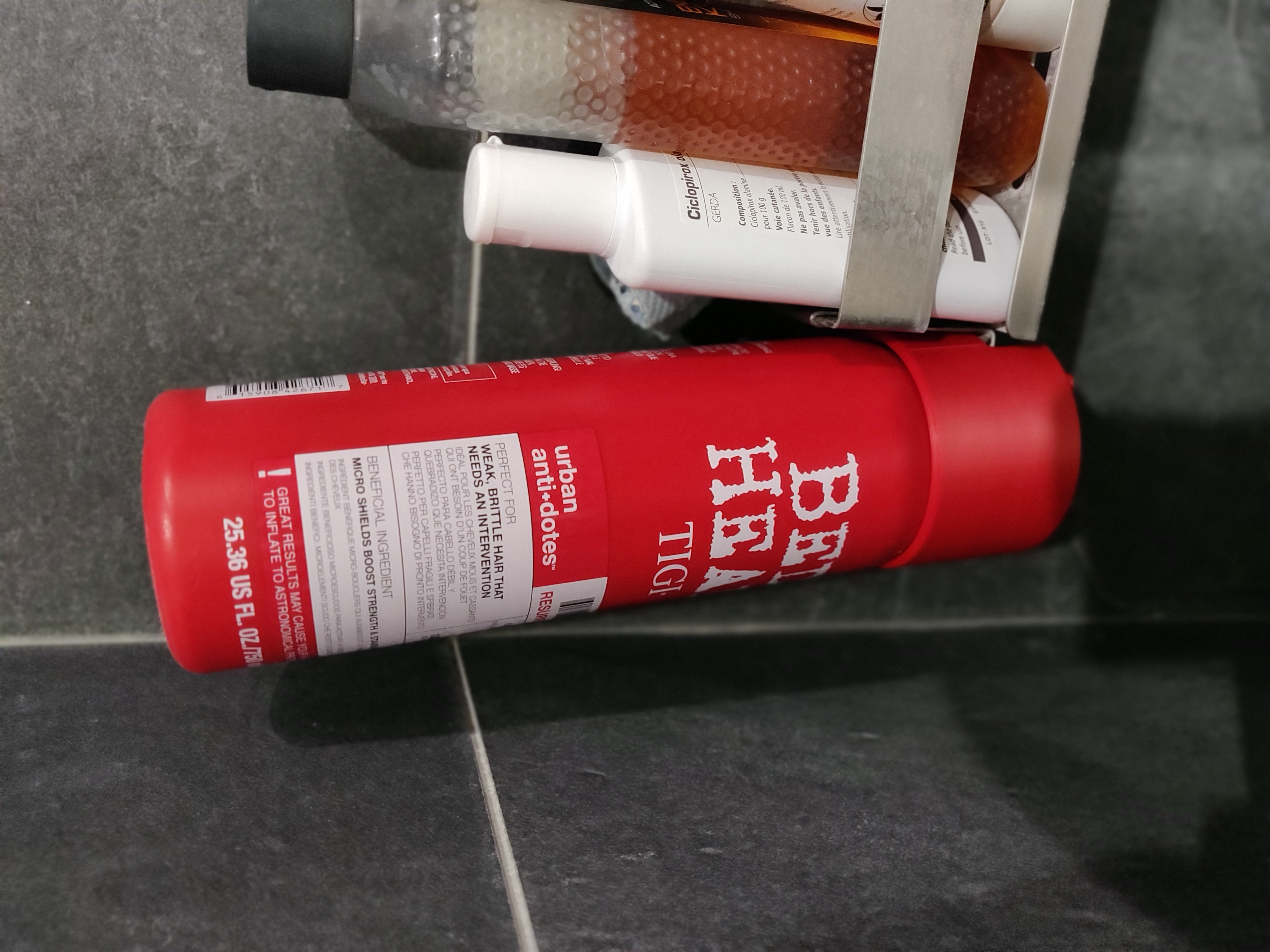 Upside-down Tigi Bed Head shampoo holder