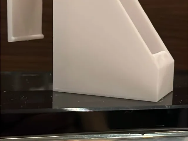 Spray bottle holder for a ledge