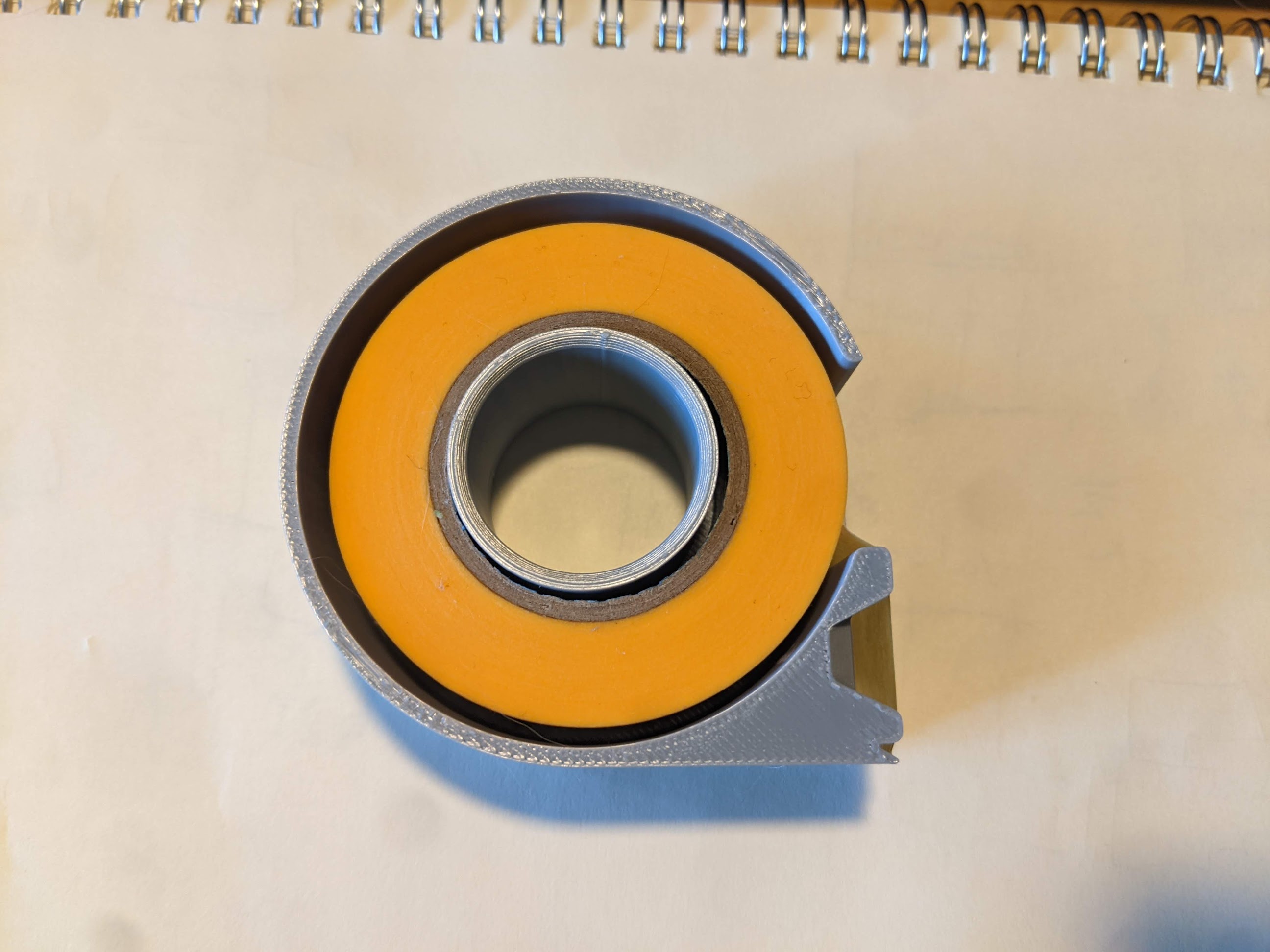 Compact masking tape dispenser
