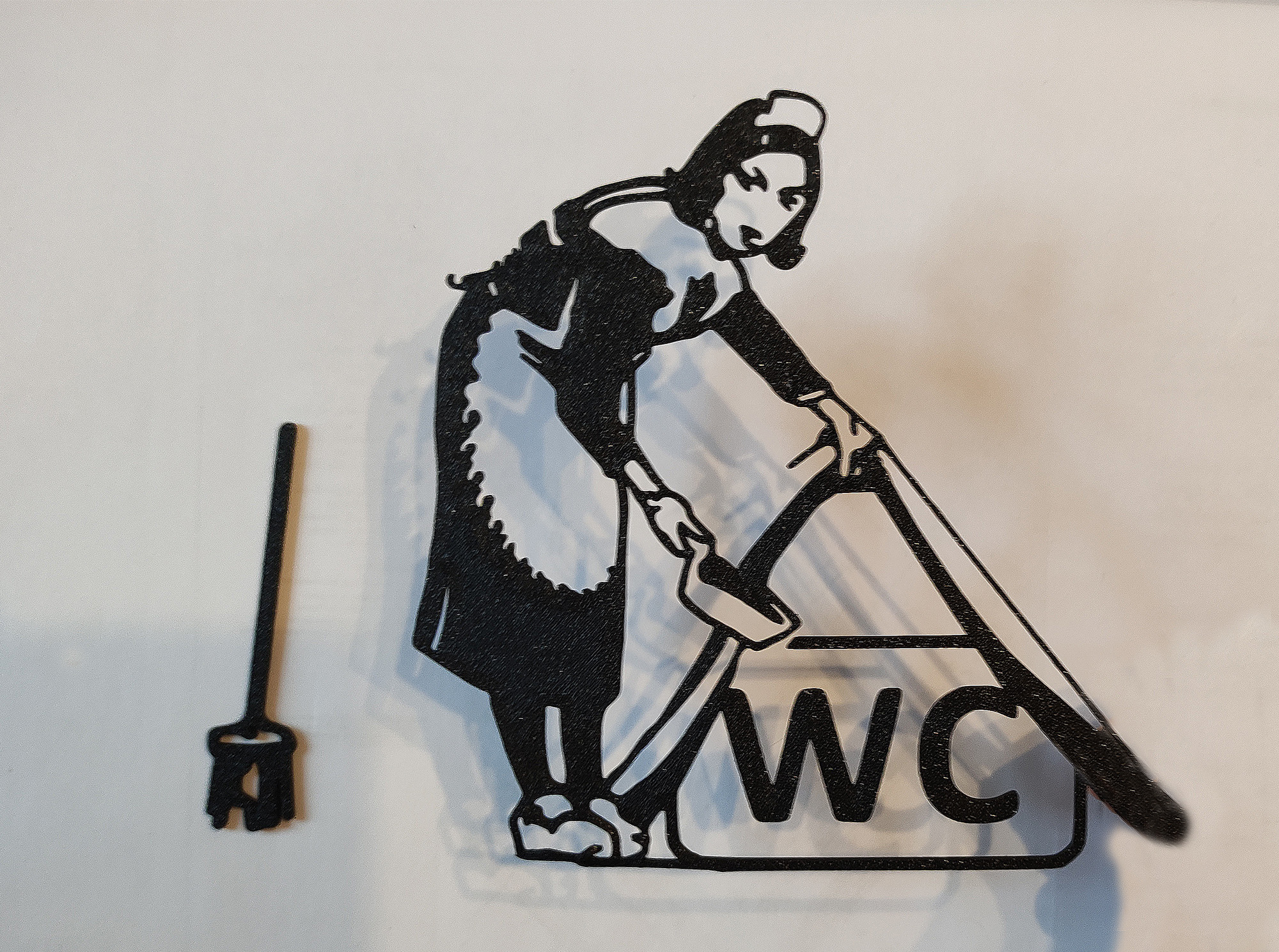 WC door hanger inspired by the work of the legendary artist Banksy.