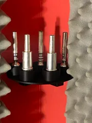 Trumpet mouthpiece stand for corner wall mounting.