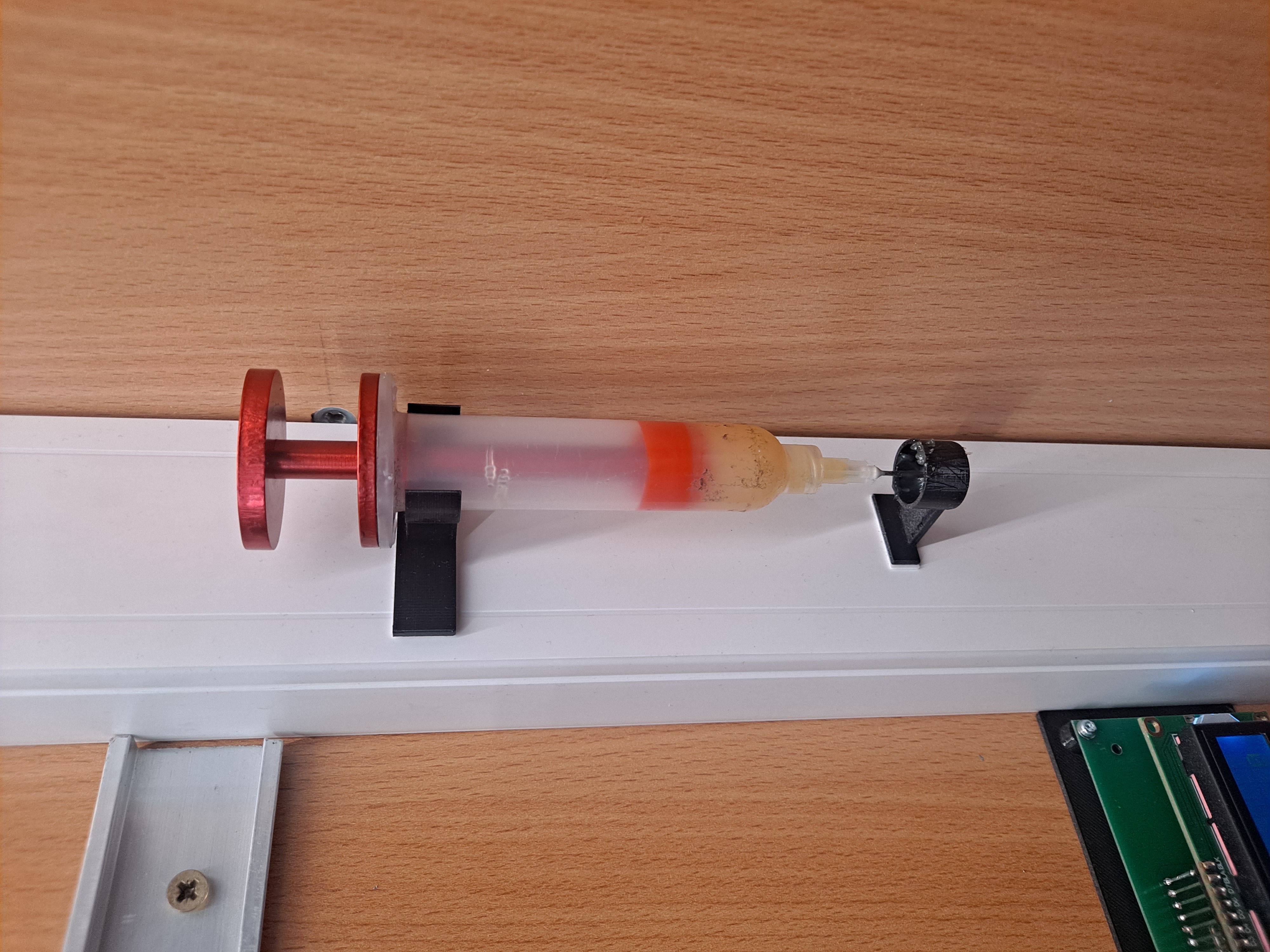 Wall holder for syringe with solder flux or solder paste.