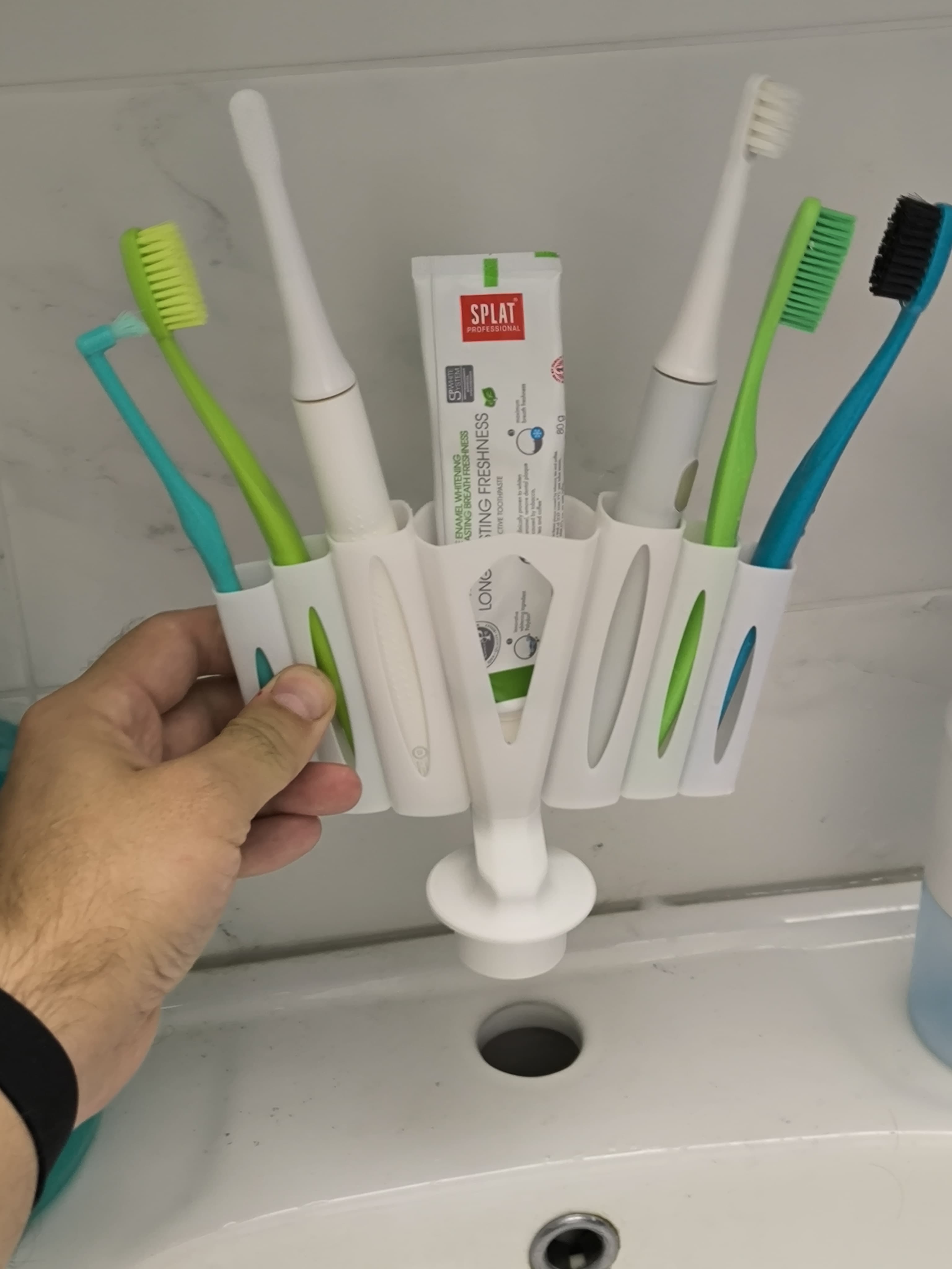 Plug on the sink. Organizer for toothbrushes.