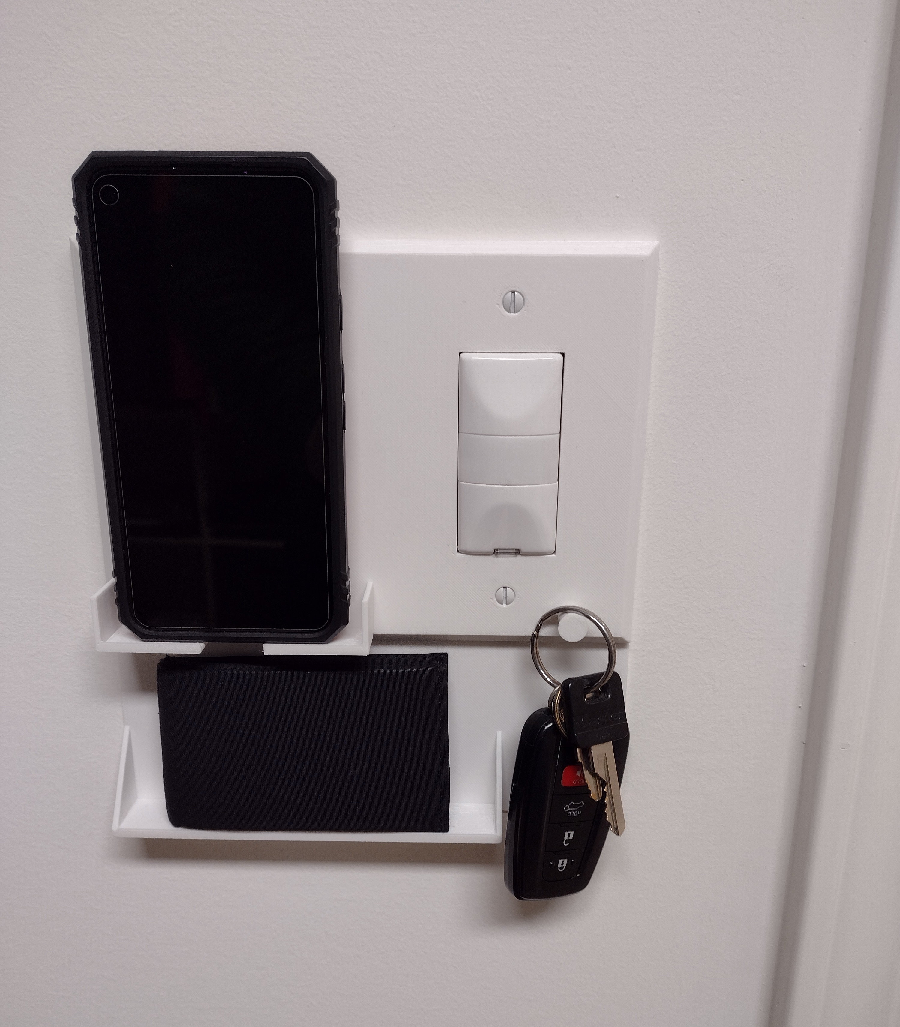 Wall switch/outlet plate that also holds your phone