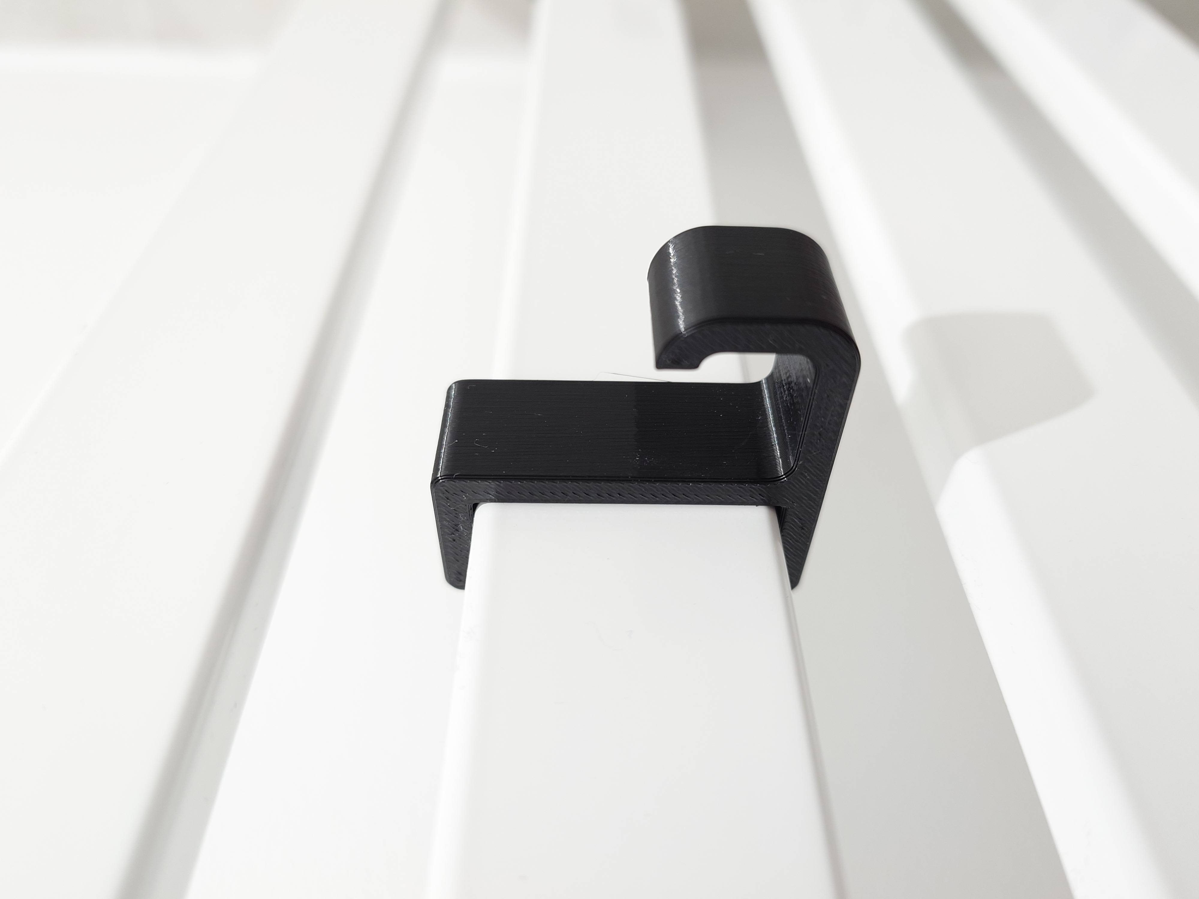 Towel hook for a bathroom radiator
