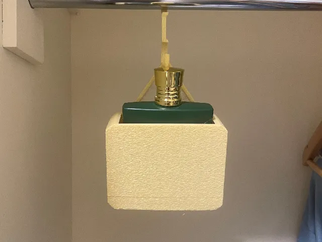 Perfume / cologne holder for closets .