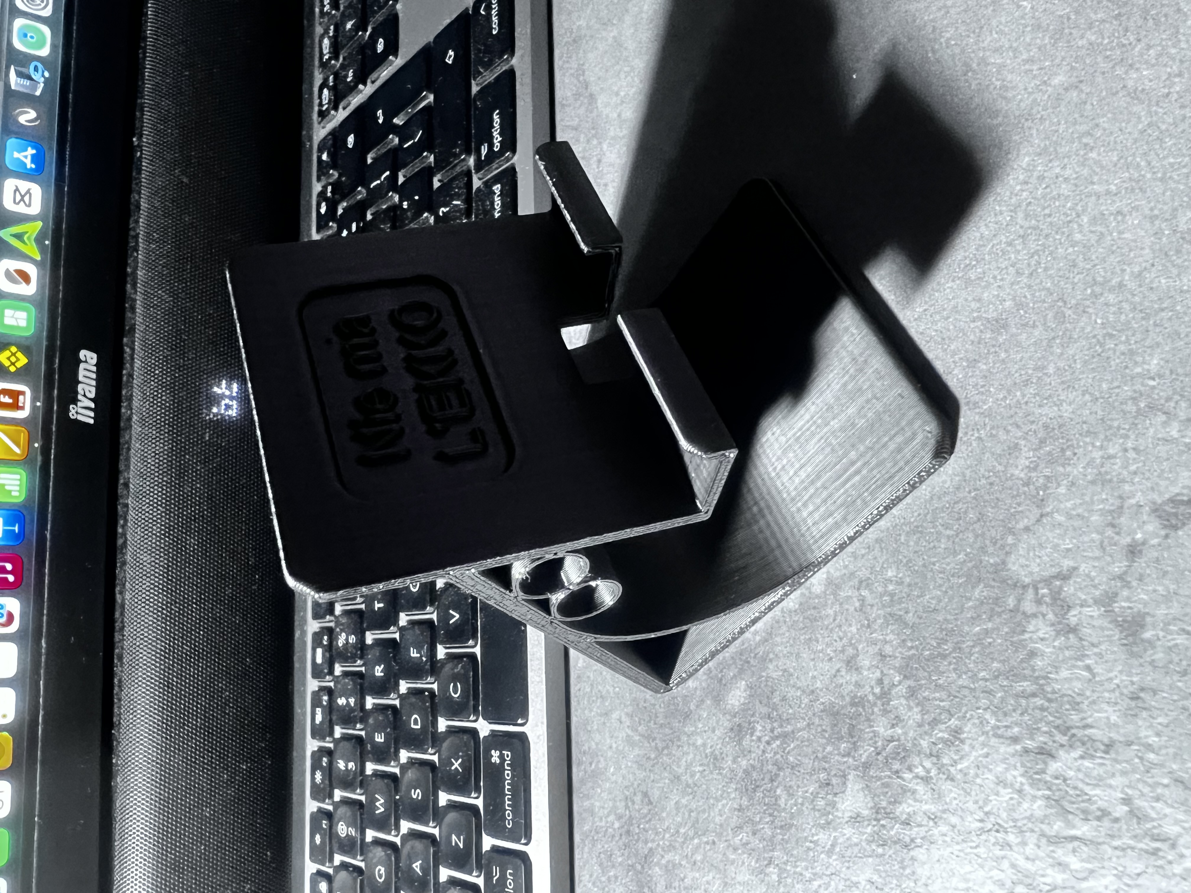 Phone stand with space for a pen.