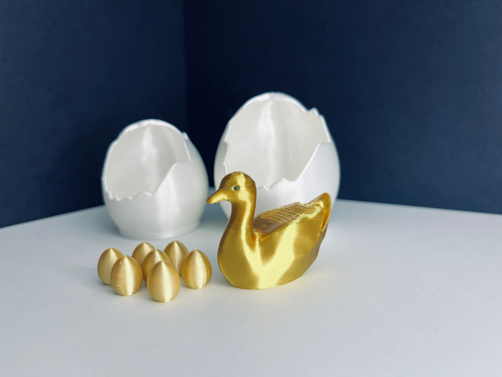 Golden goose with hatched egg and 7 golden eggs