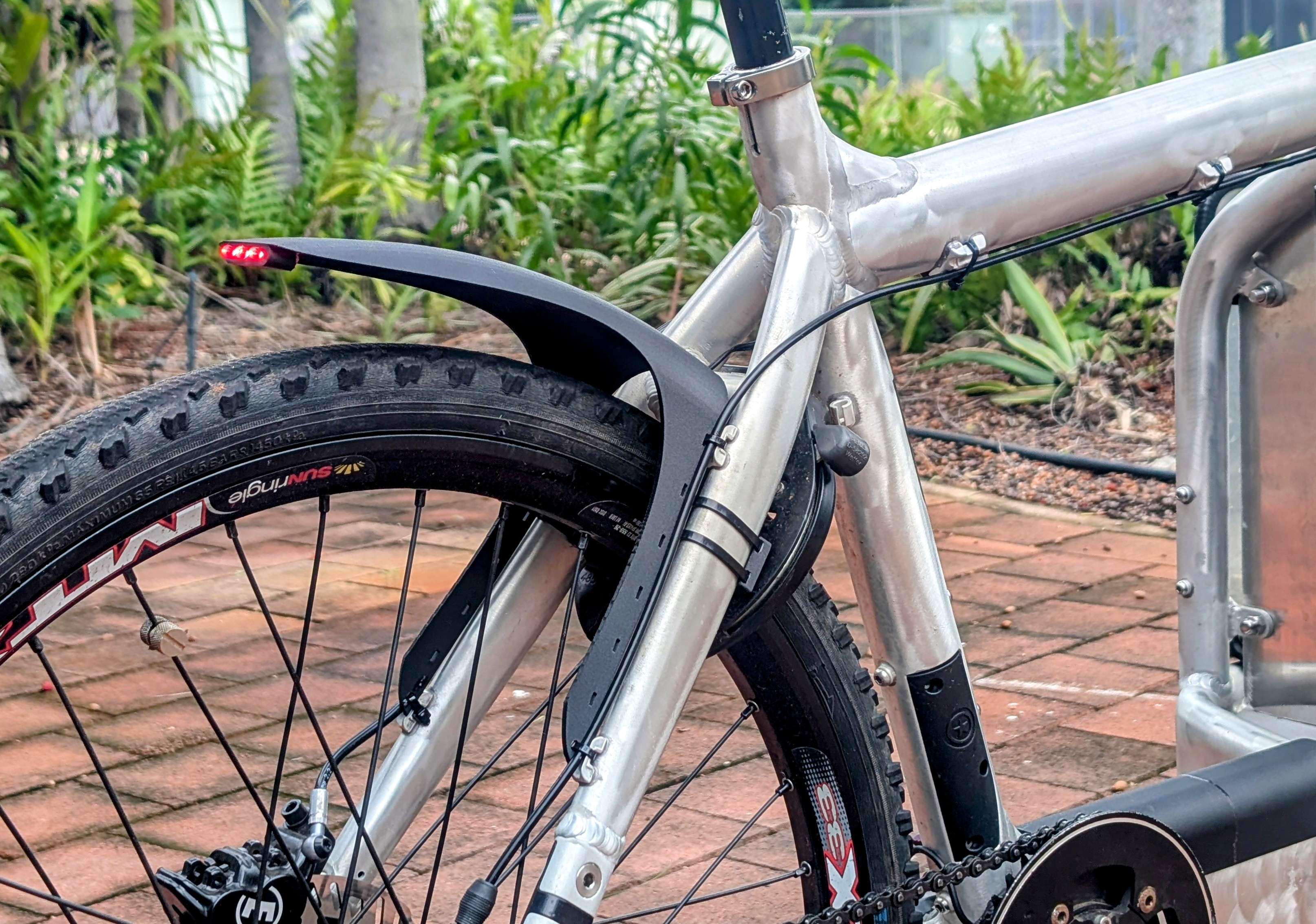 Bicycle mudguard with integrated LED tail light.