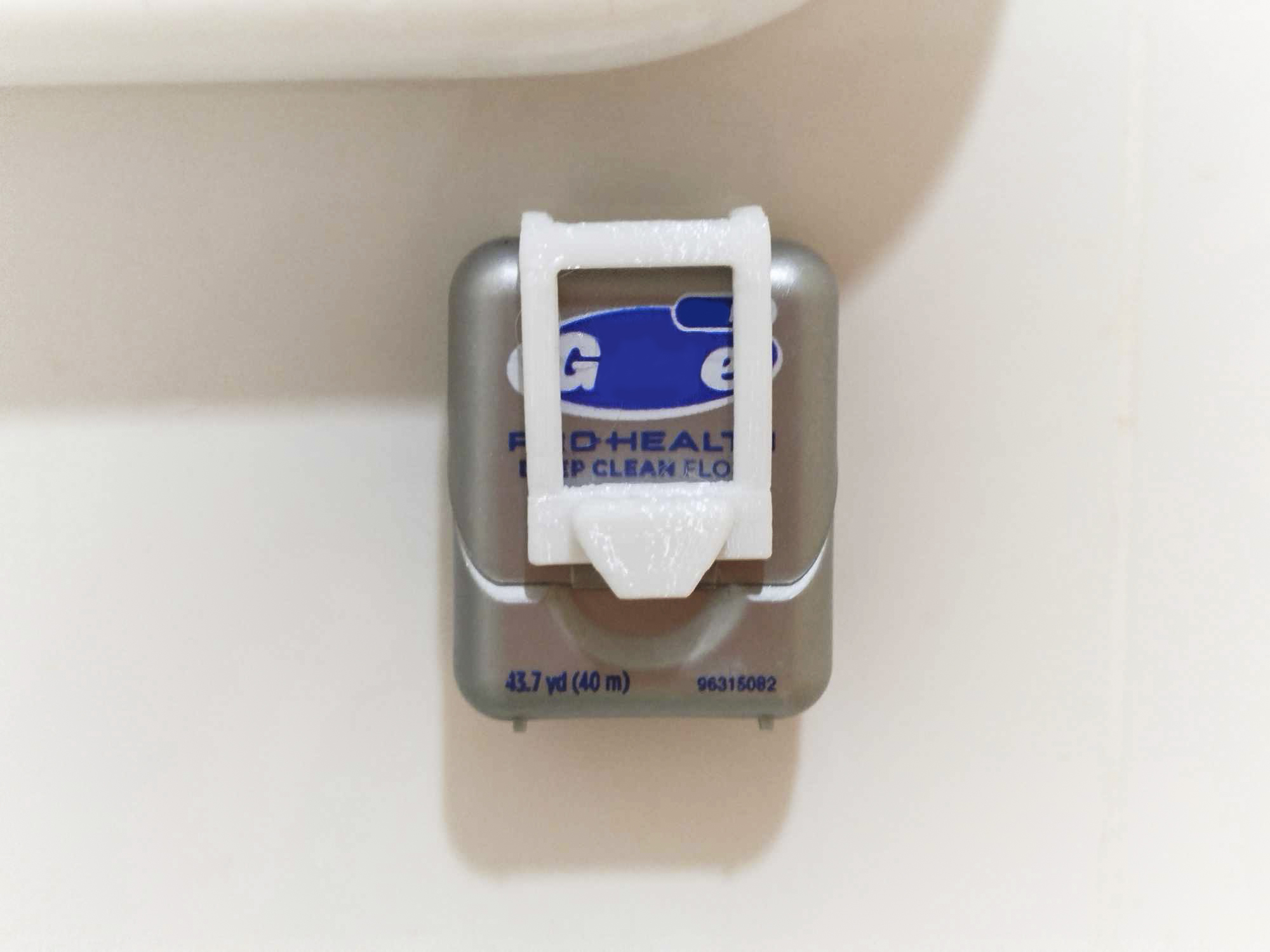 Wall-mounted dental floss holder