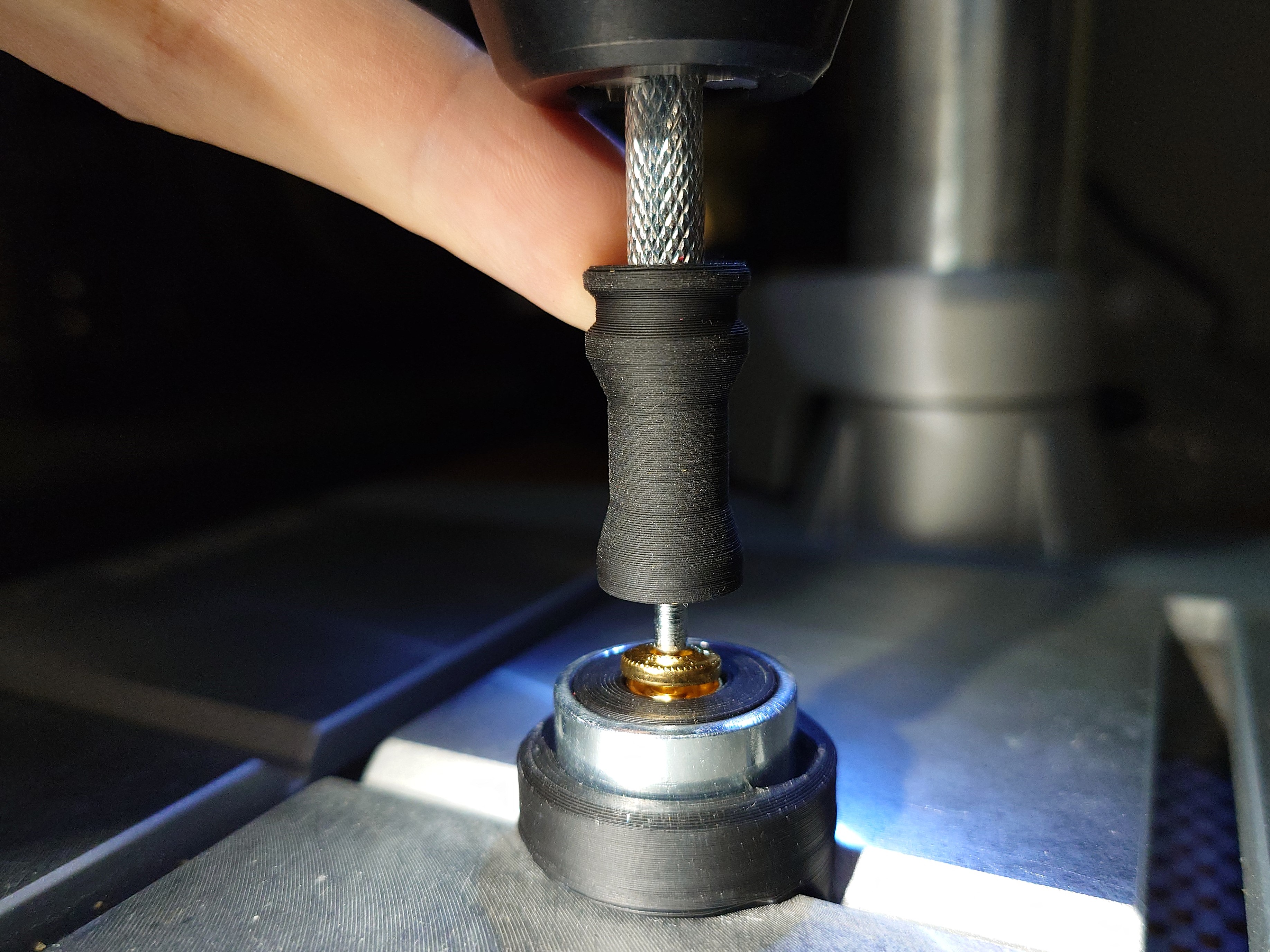 Snap button riveting tool improvements
