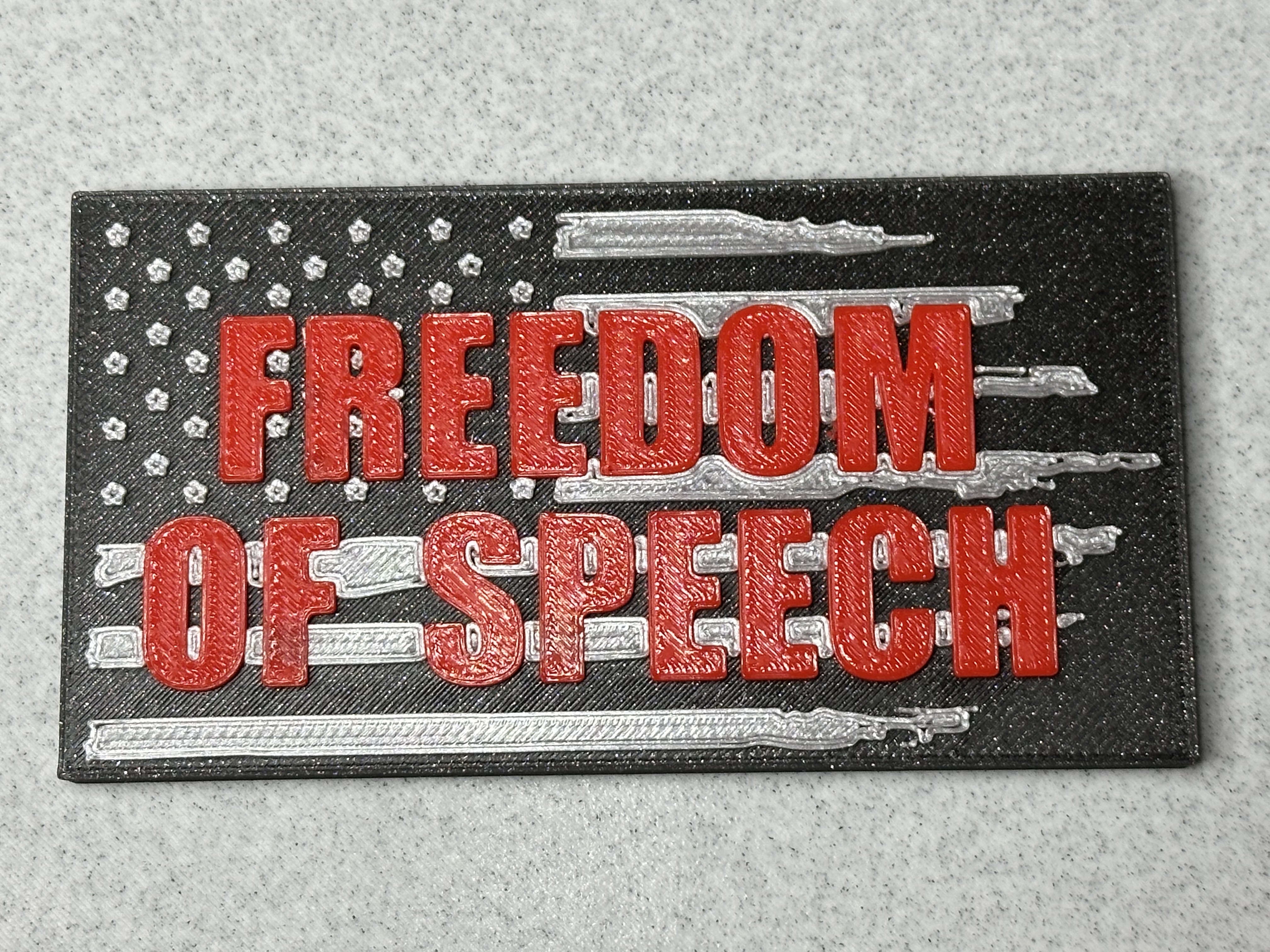 Freedom of Speech sign with American flag