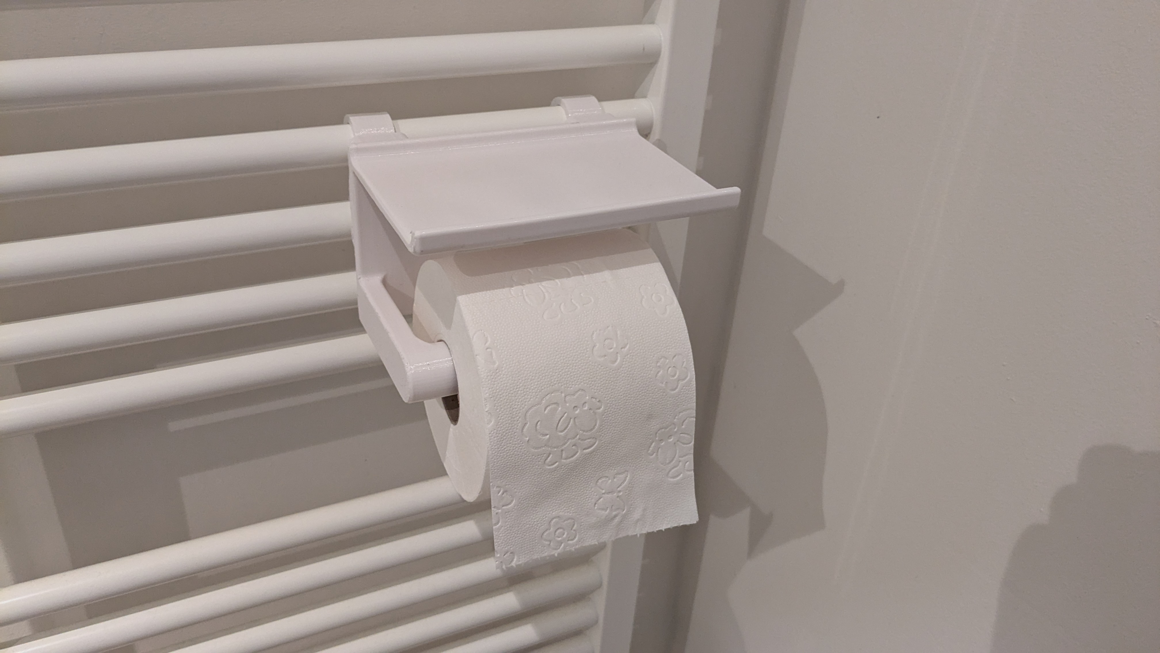 Radiator toilet paper holder