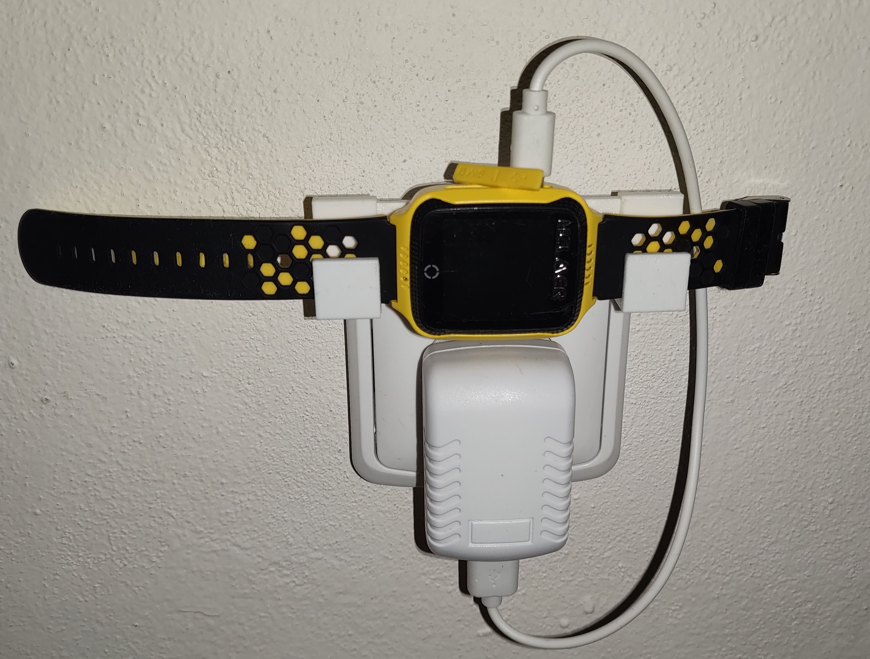 Power socket attached holder for charged device