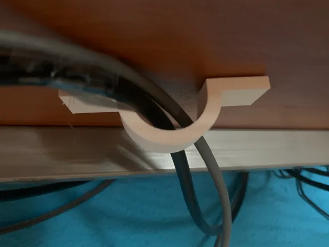 Cable holder under the table