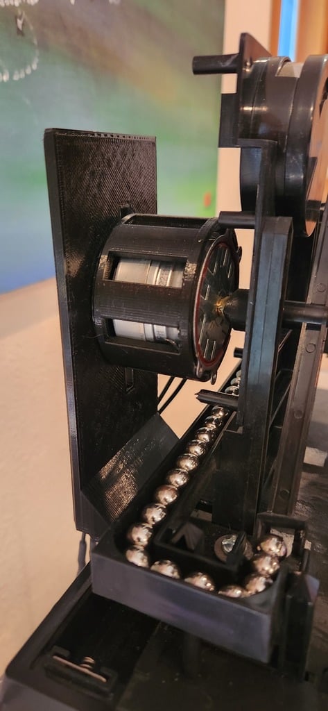 Motor mount used with a refitted rolling ball clock. 