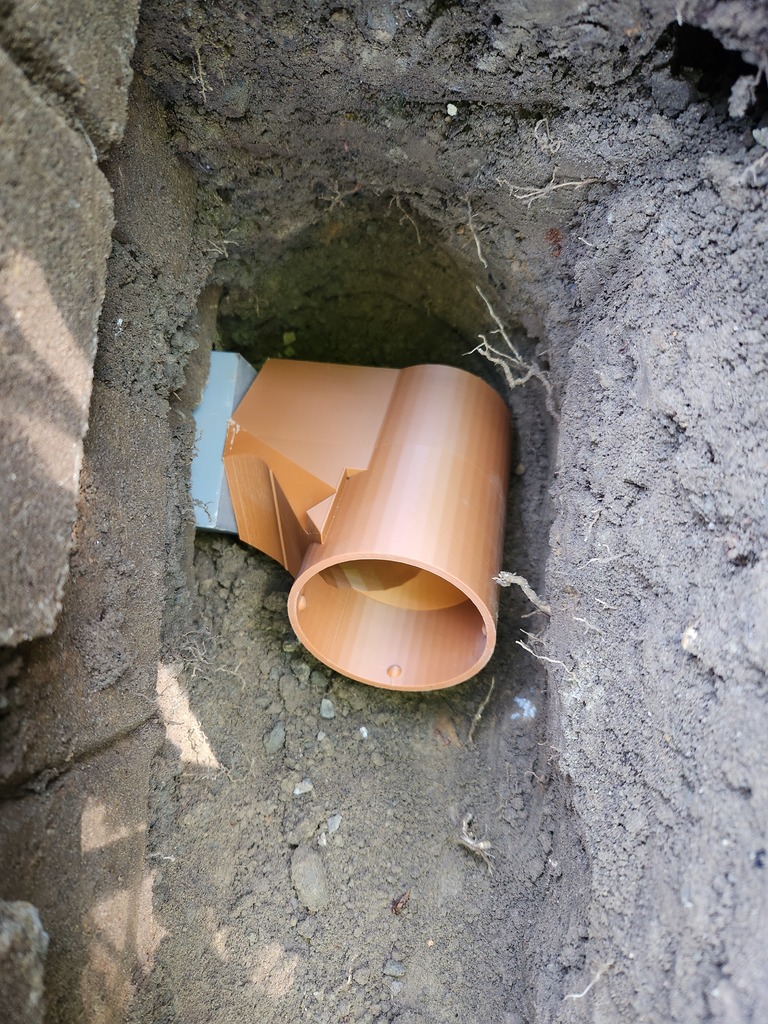Corrugated Drain Pipe Outlet from 4" Block Wall (after-assembly pass-through)