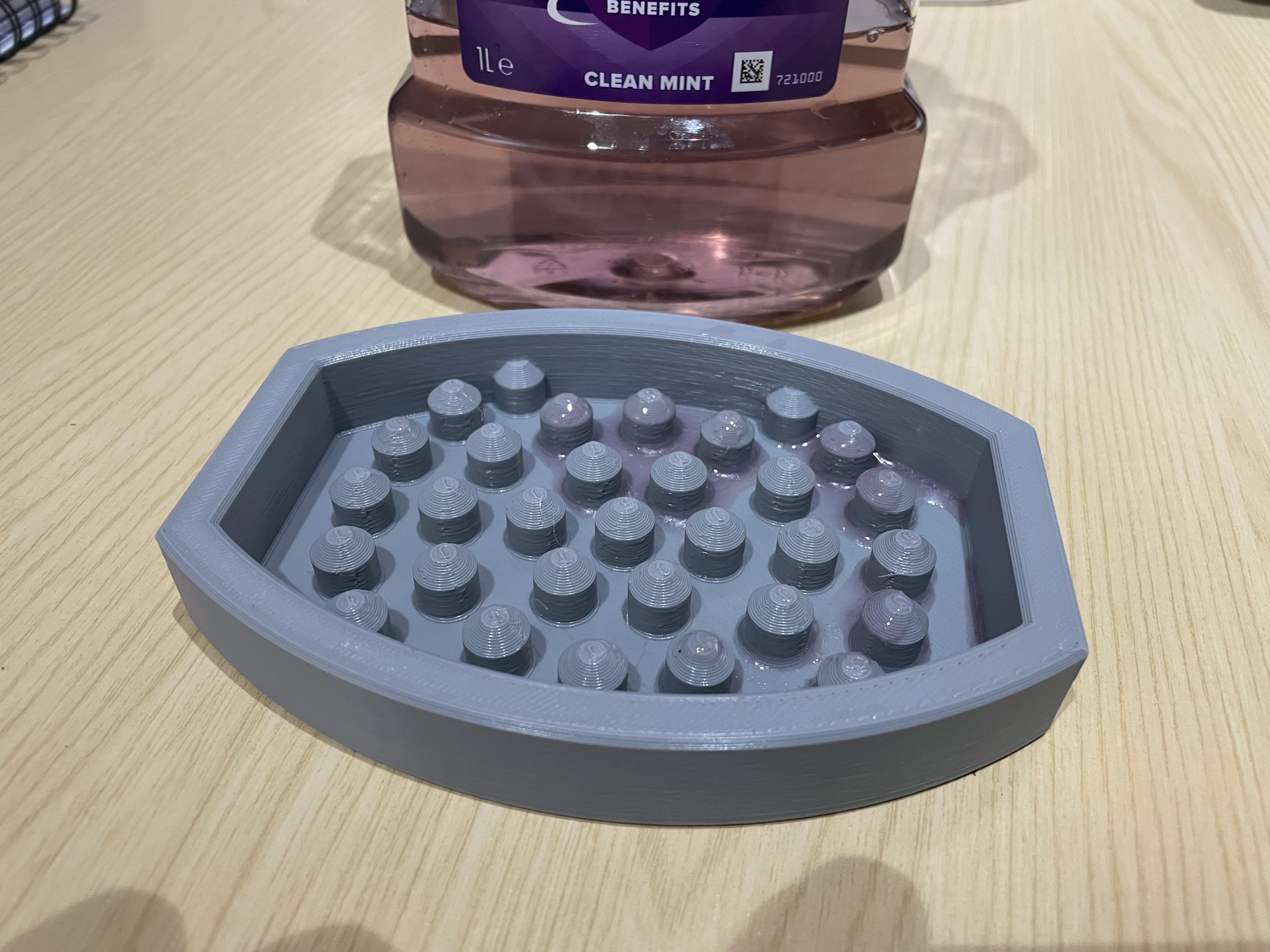 A drip tray for a 1L Listerine mouthwash bottle