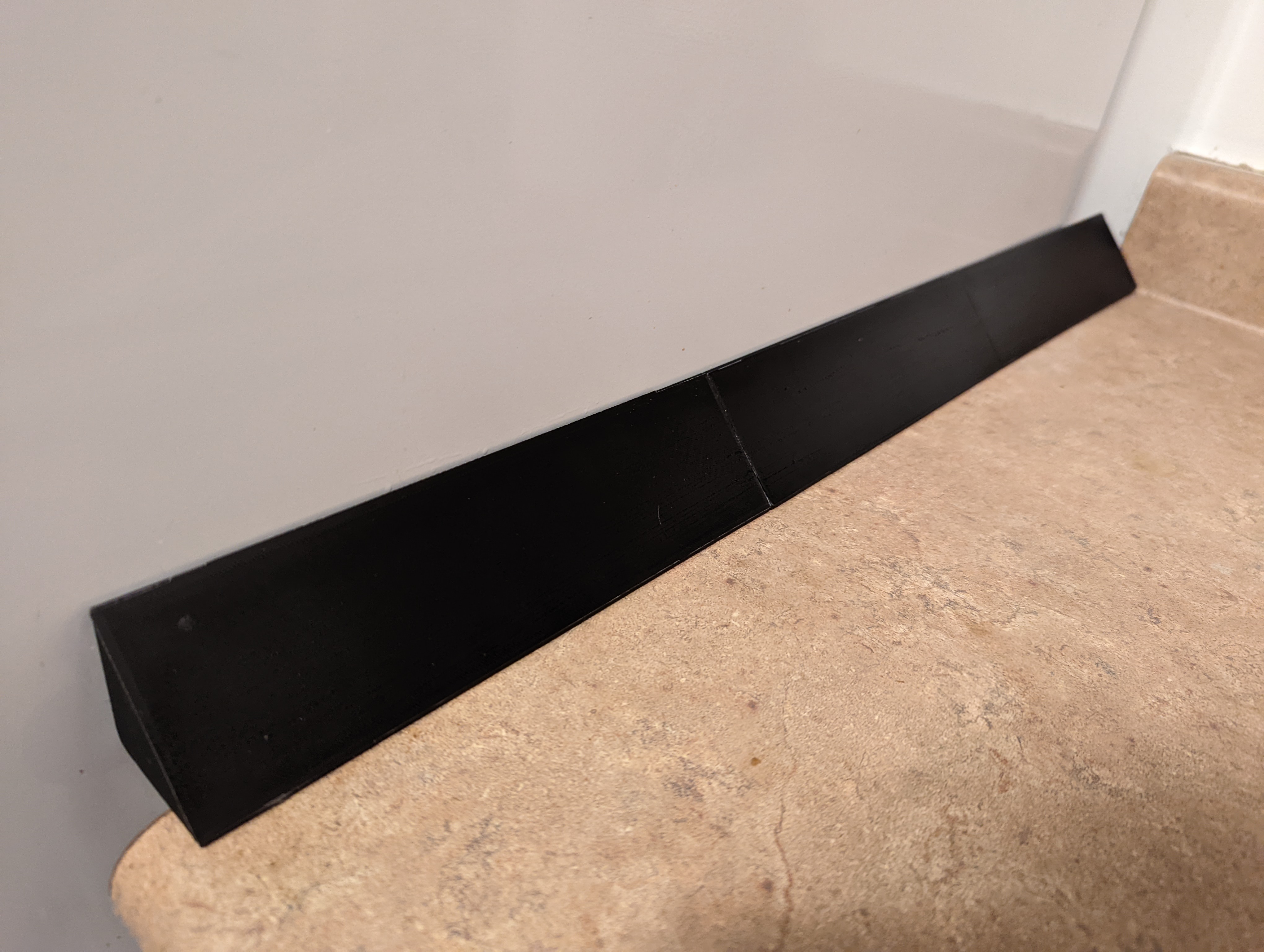 Counter top/fridge gap shield