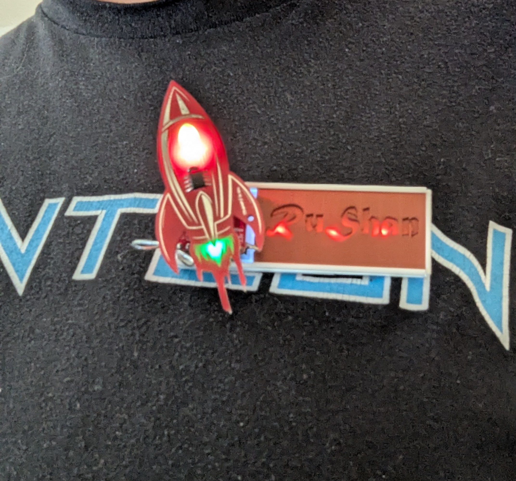 Name badge with swappable name plat for custom electronic board