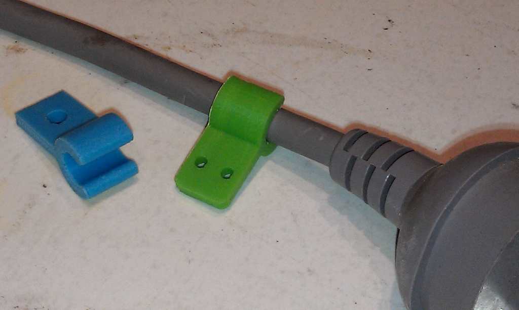 Cable clip with screw or nail fixing tab