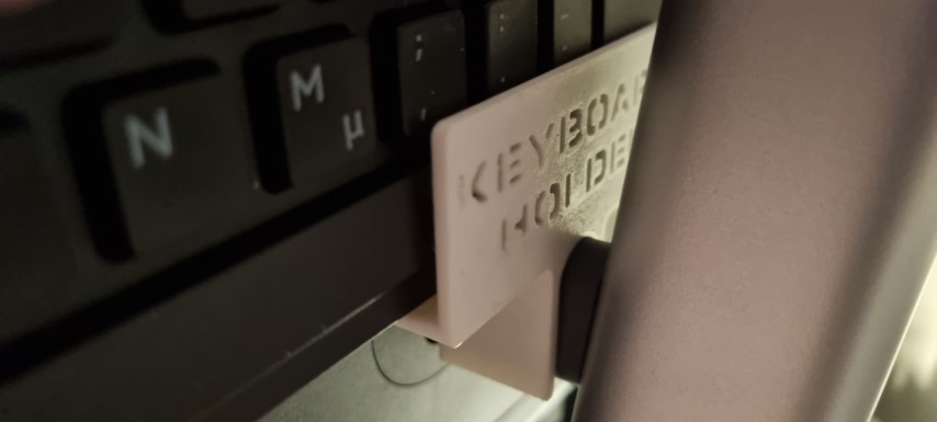 Keyboard holder on top of a monitor